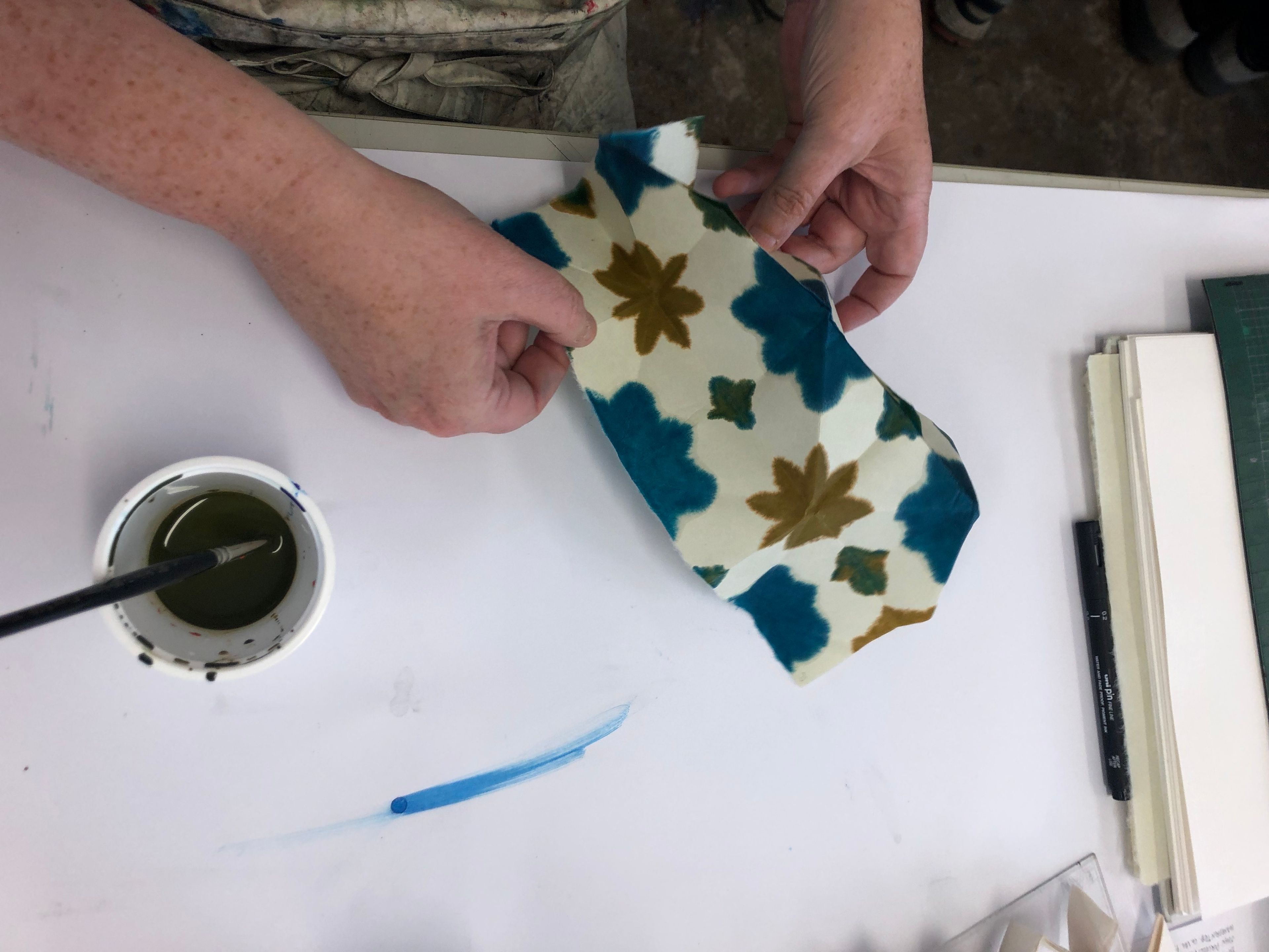 photo of marbling in process; ink and marbled print