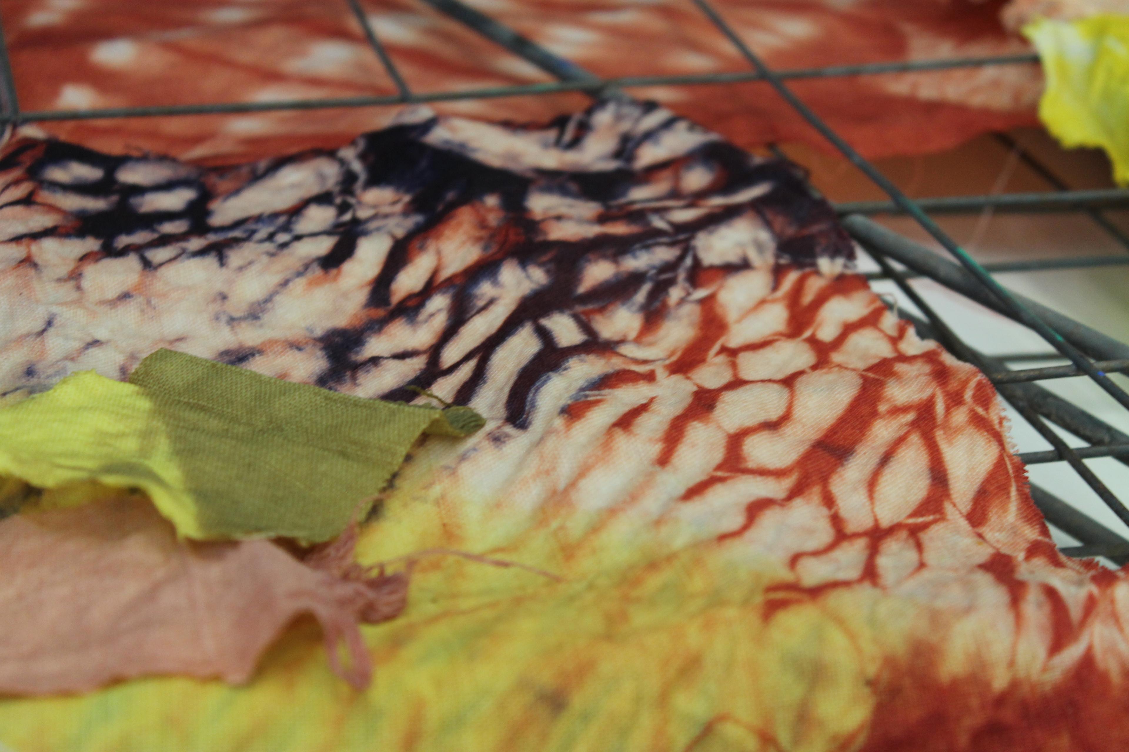 photo of shibori dyed textiles orange yellow and purple pattern