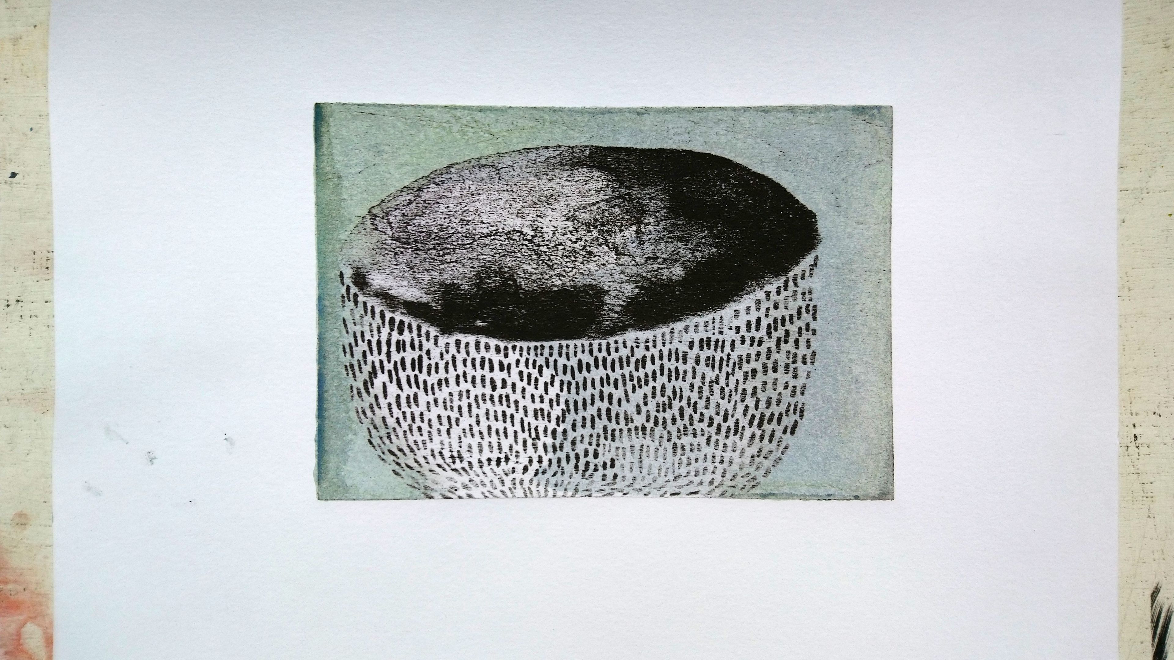 lithography print; black and white textured archaeological bowl against muted green background