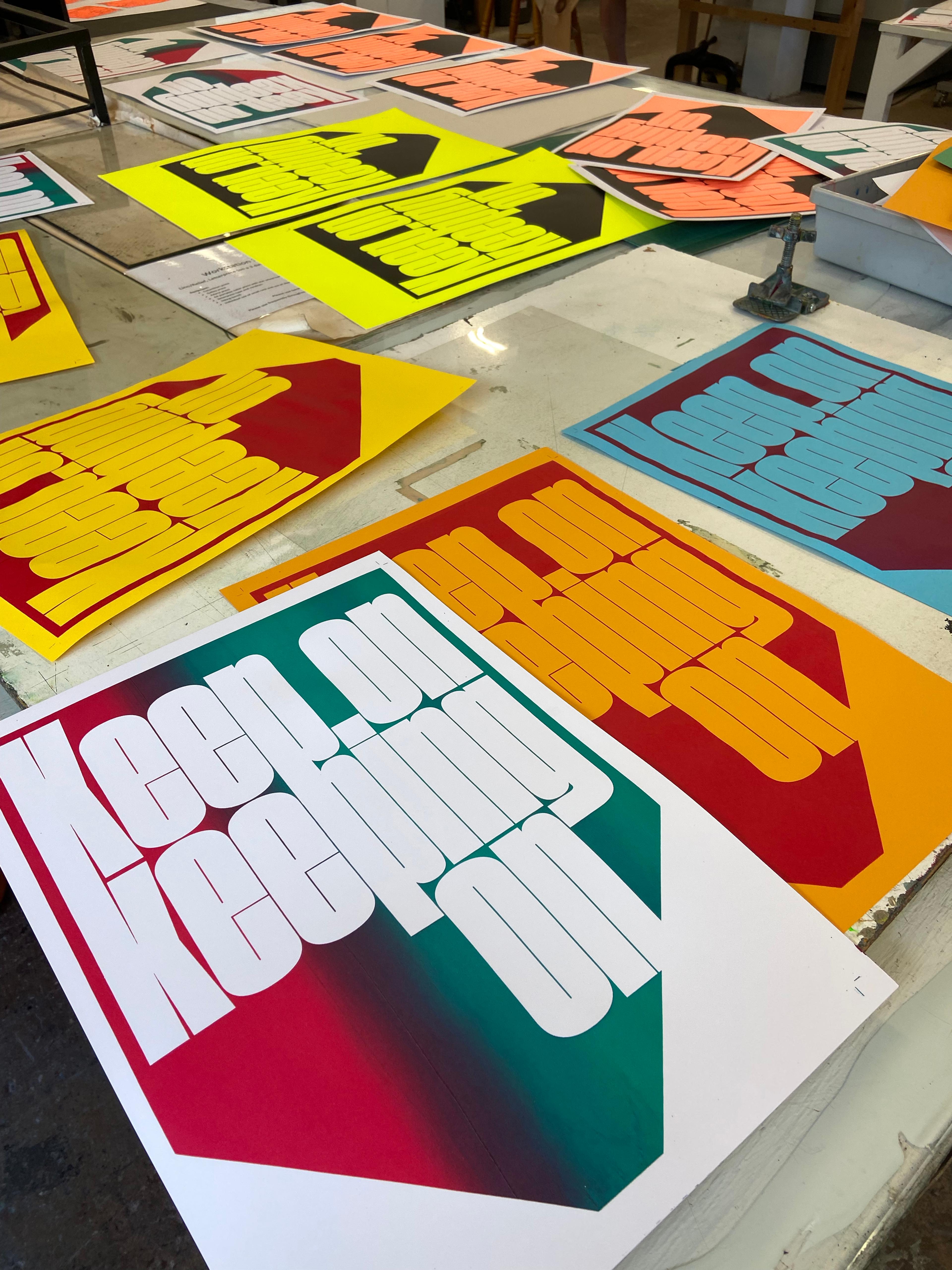 multicoloured screenprints of Keep on Keeping on text