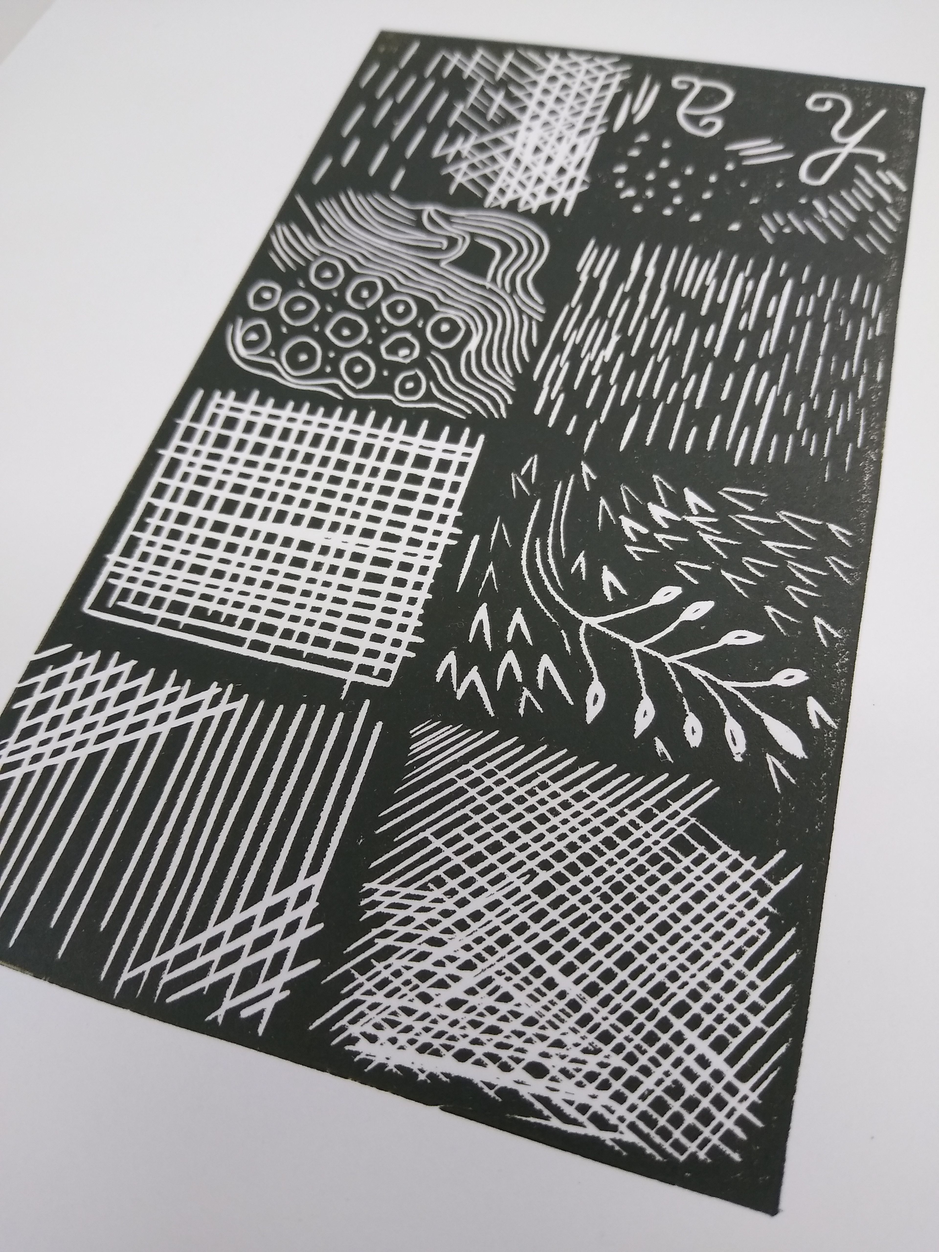 linocut block representing different cutting patterns; black and white