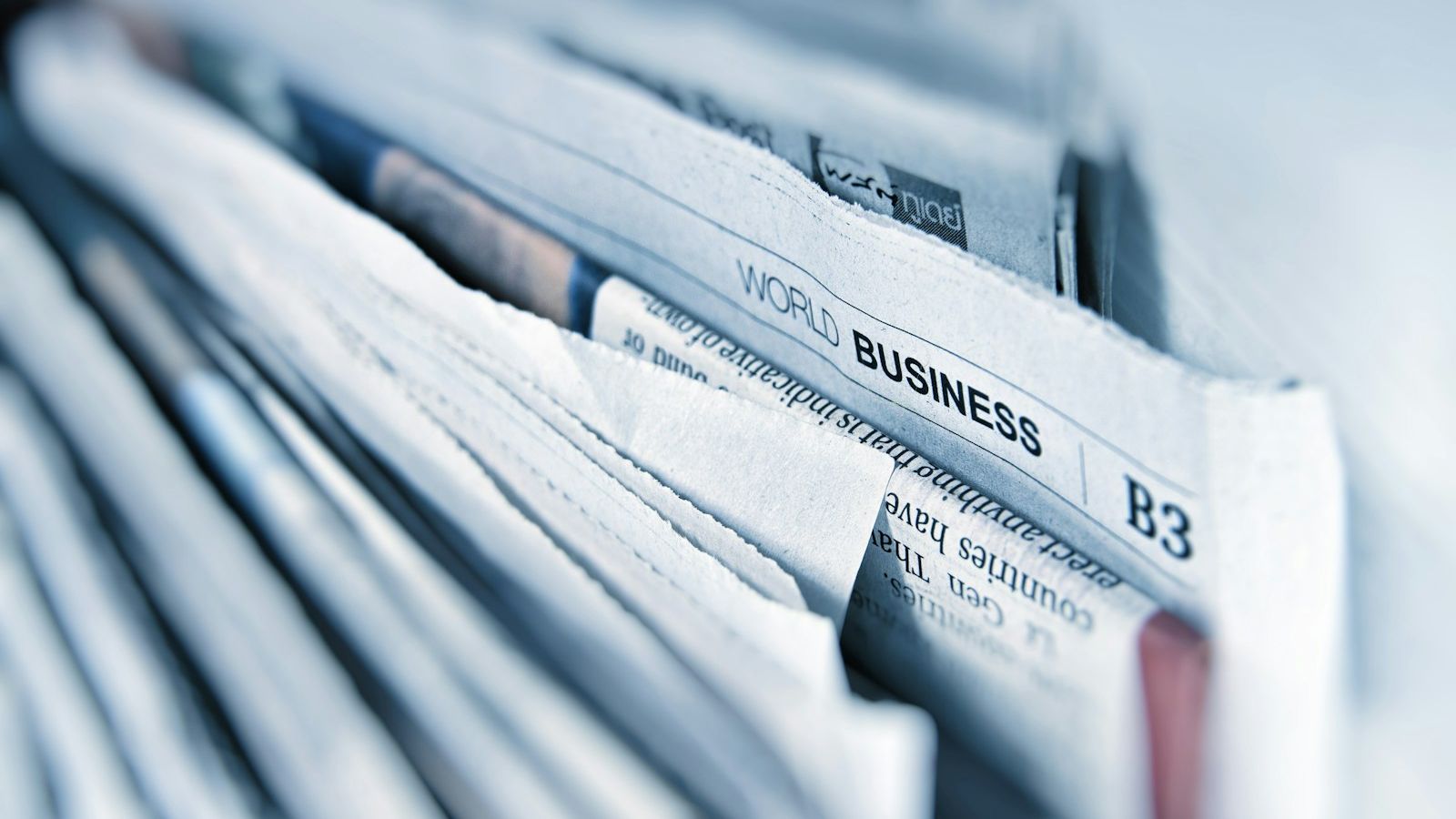 Newspapers and reading glasses on a desk