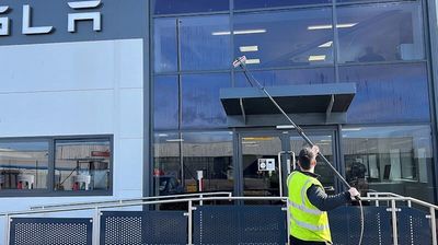 Man cleaning Tesla building