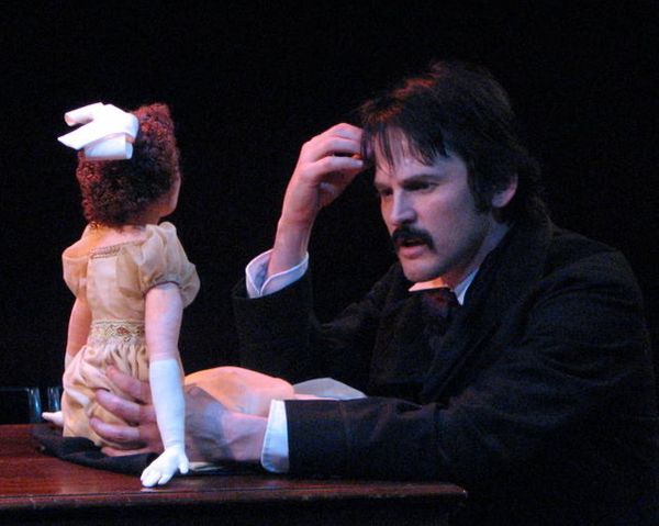 Poe looking at a doll