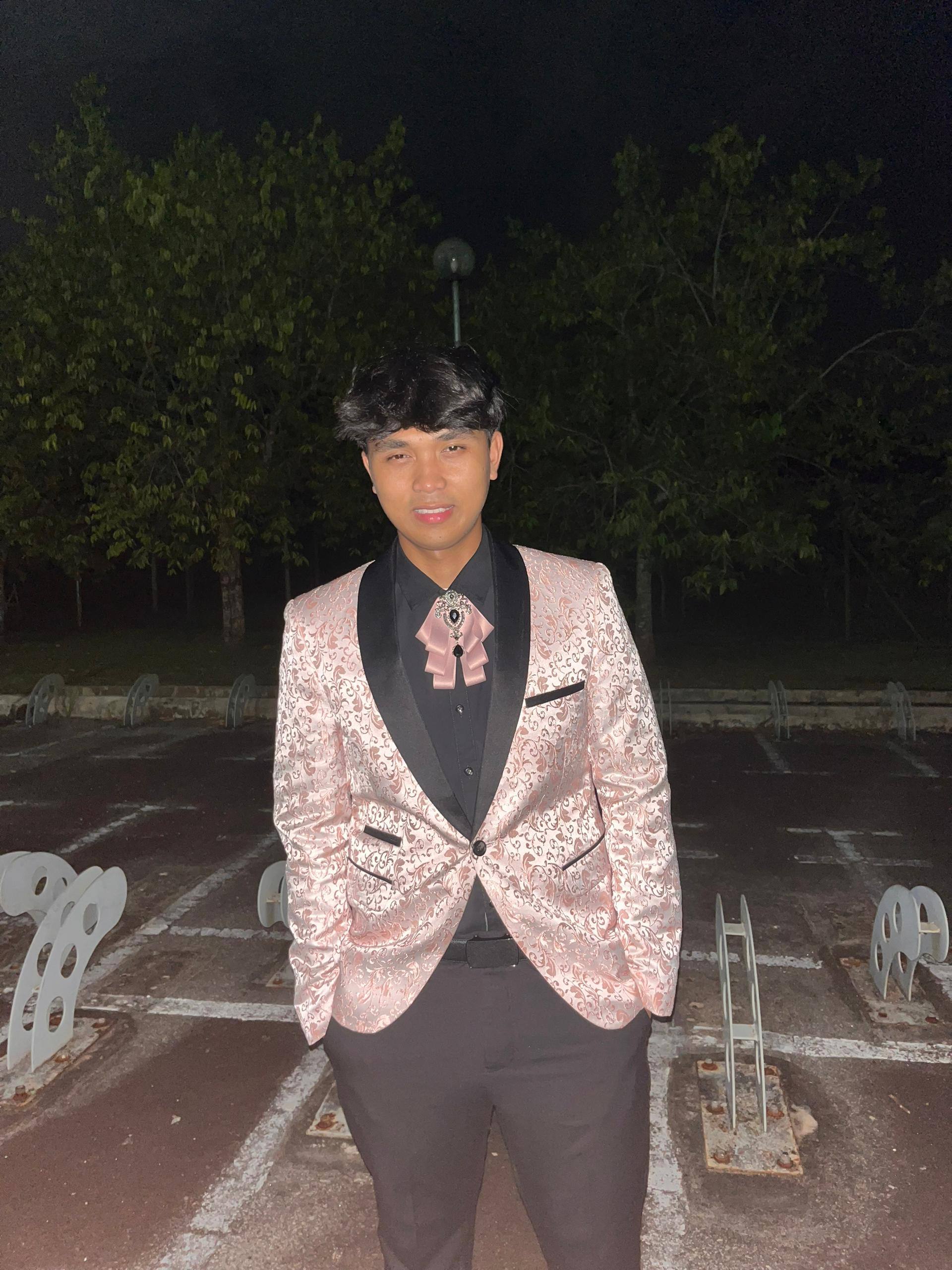 Professional portrait of Farish Hakimi in a stylish patterned blazer for a personal portfolio website.