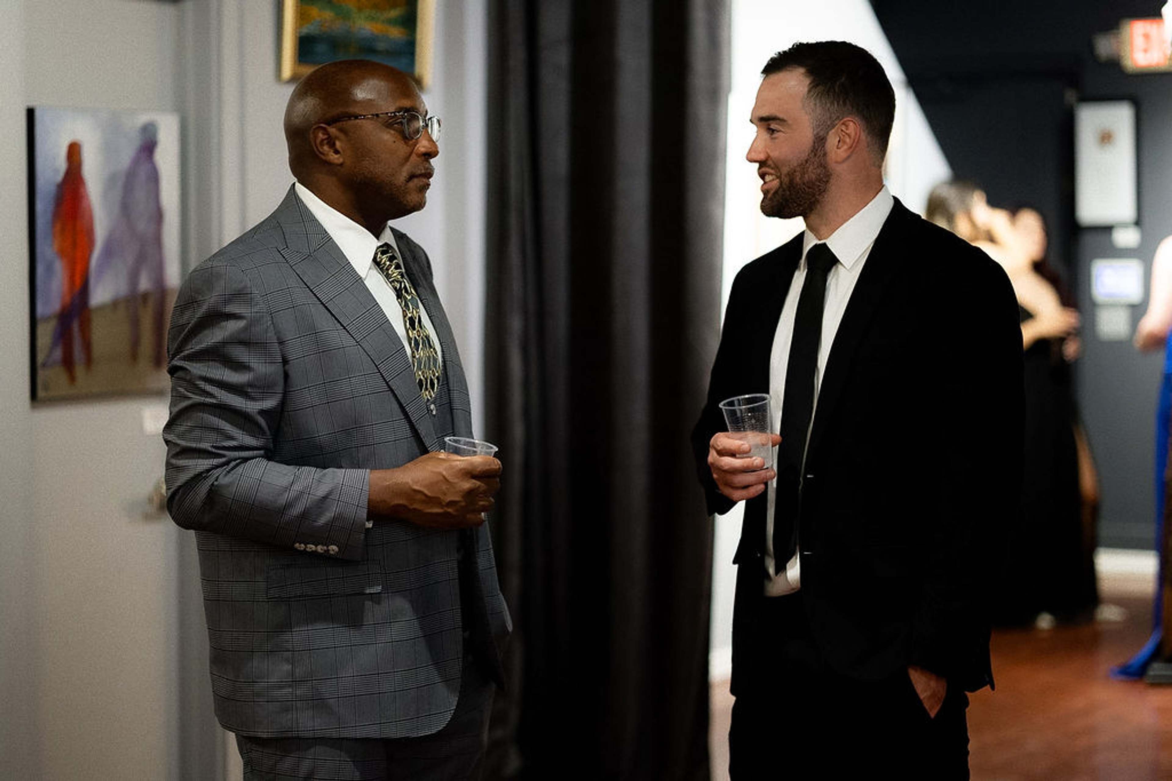 Two guests in conversation holding drinks
