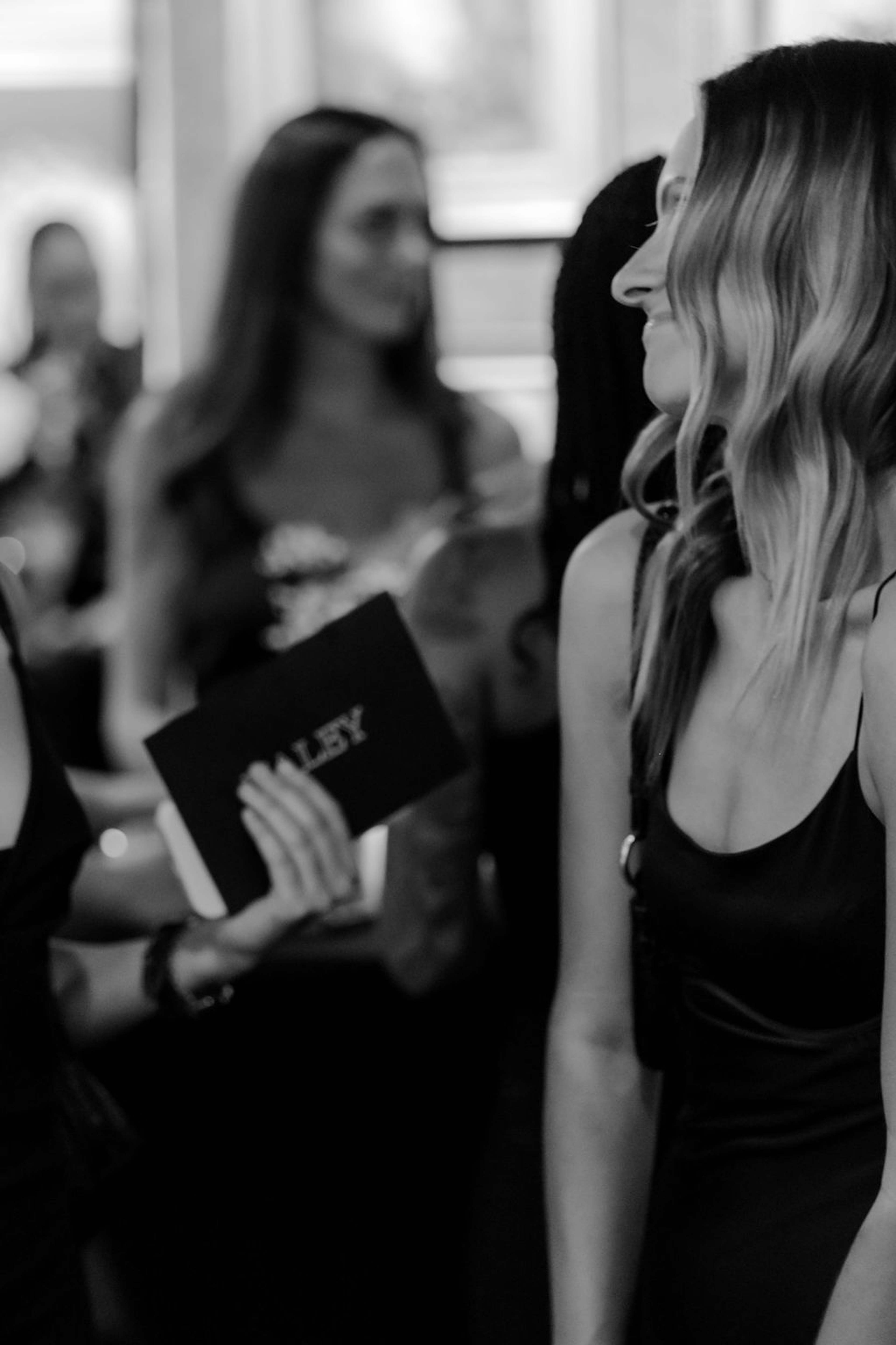 Guests in conversation, one holding the evening's programme
