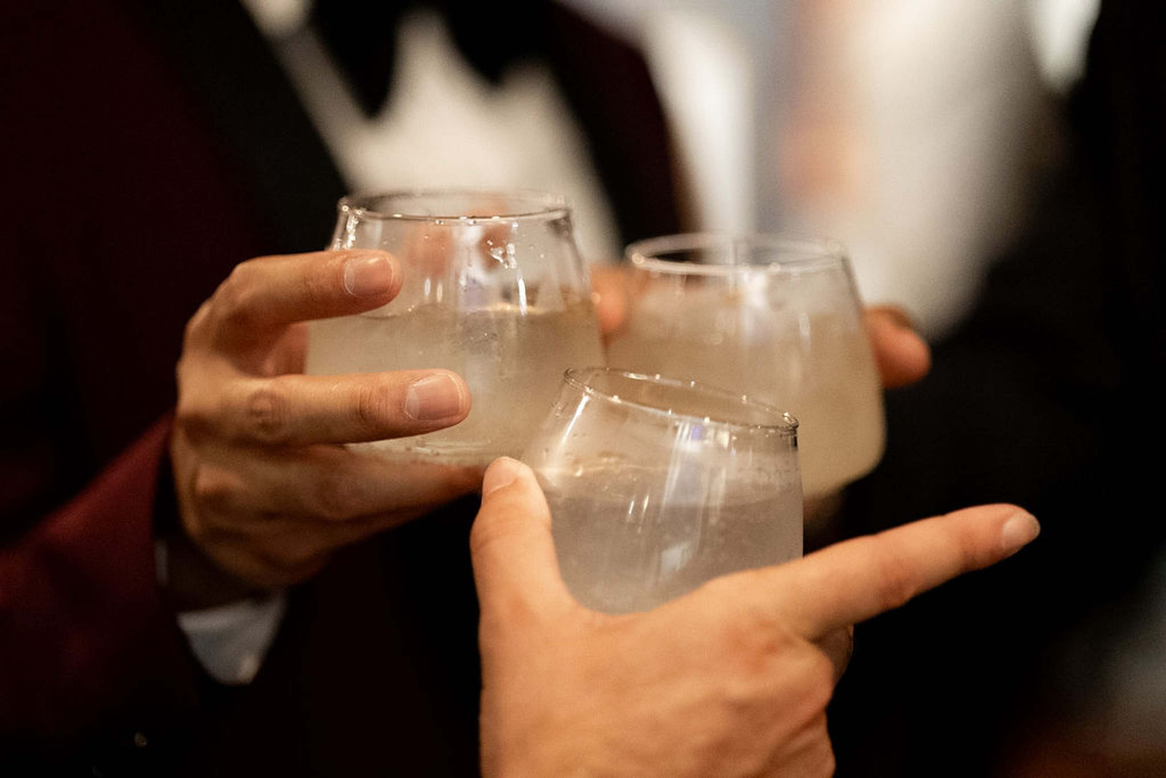 Three guests clinking glasses in a toast