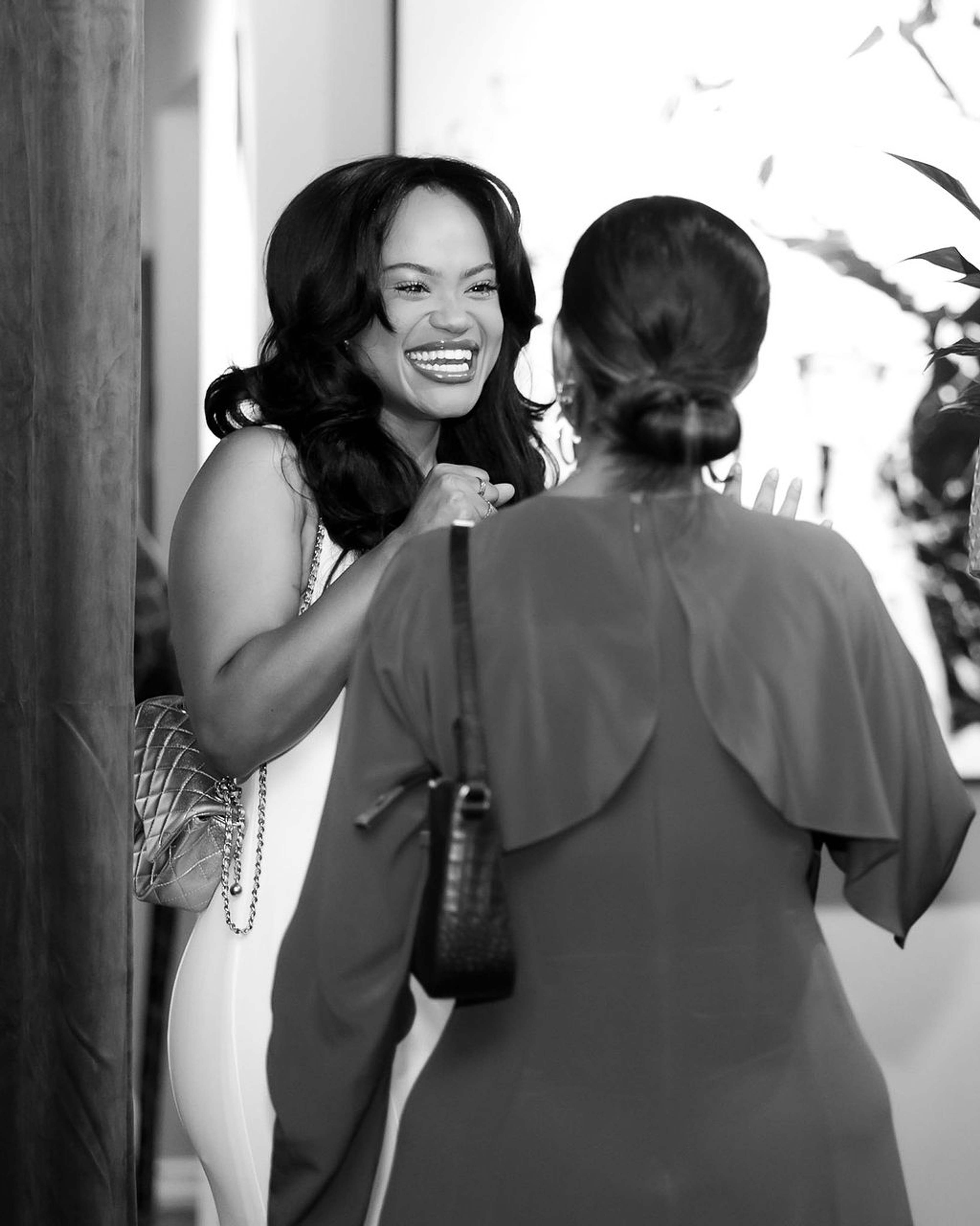 Two guests greeting one another warmly