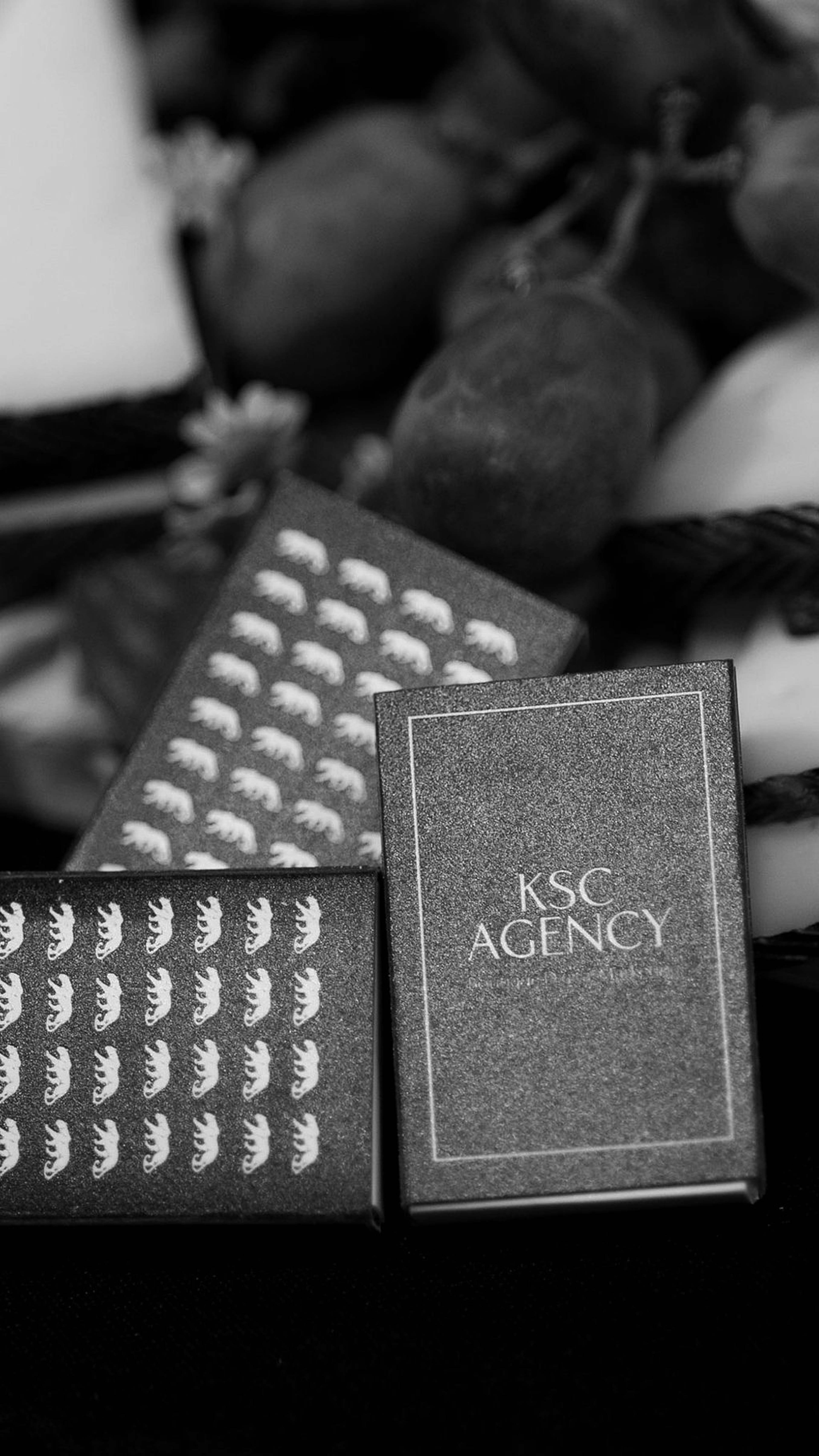 Black and white still life of a KSC Agency branded box and patterned chocolate bar