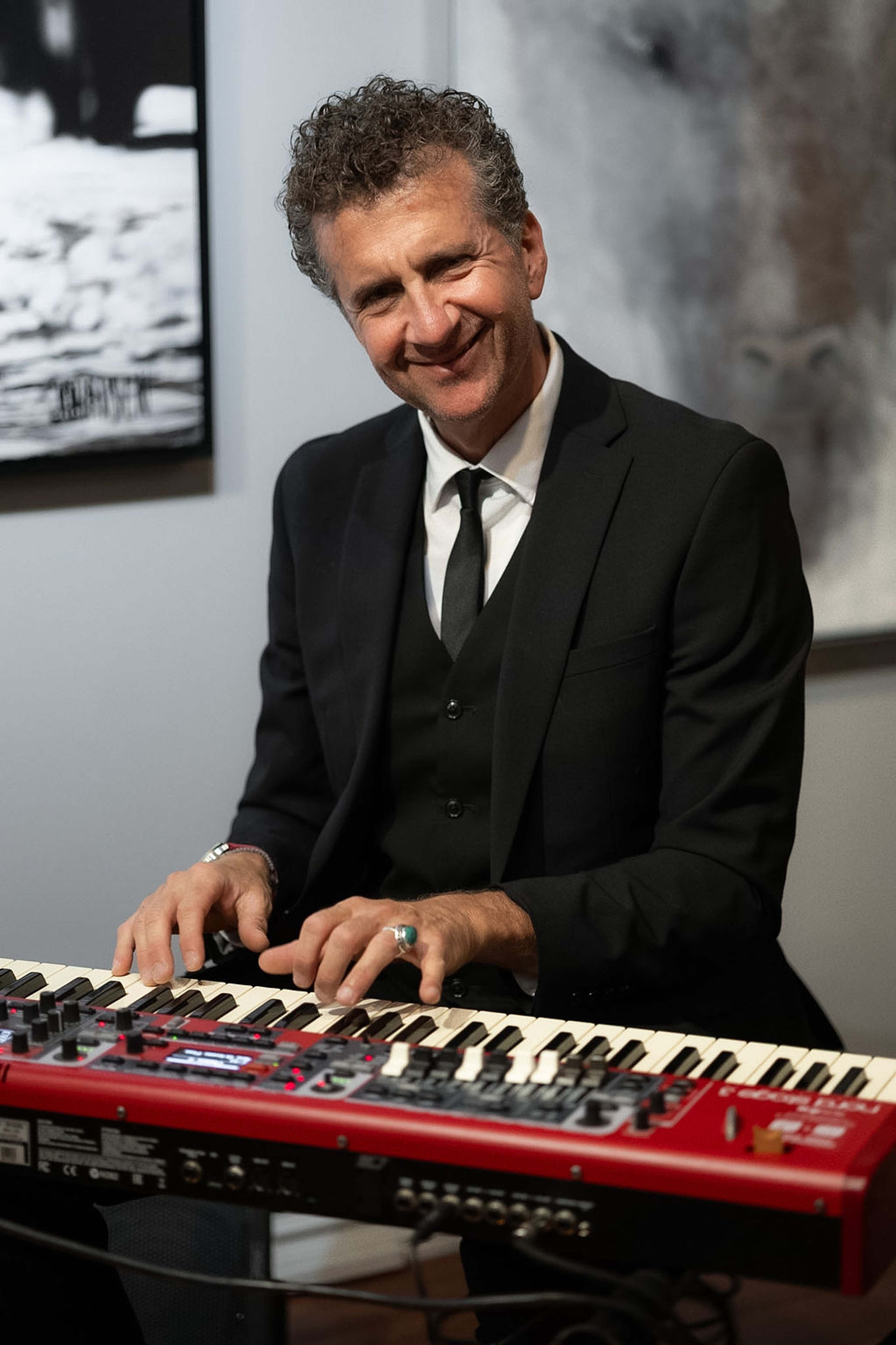 Musician smiling while playing the keyboard