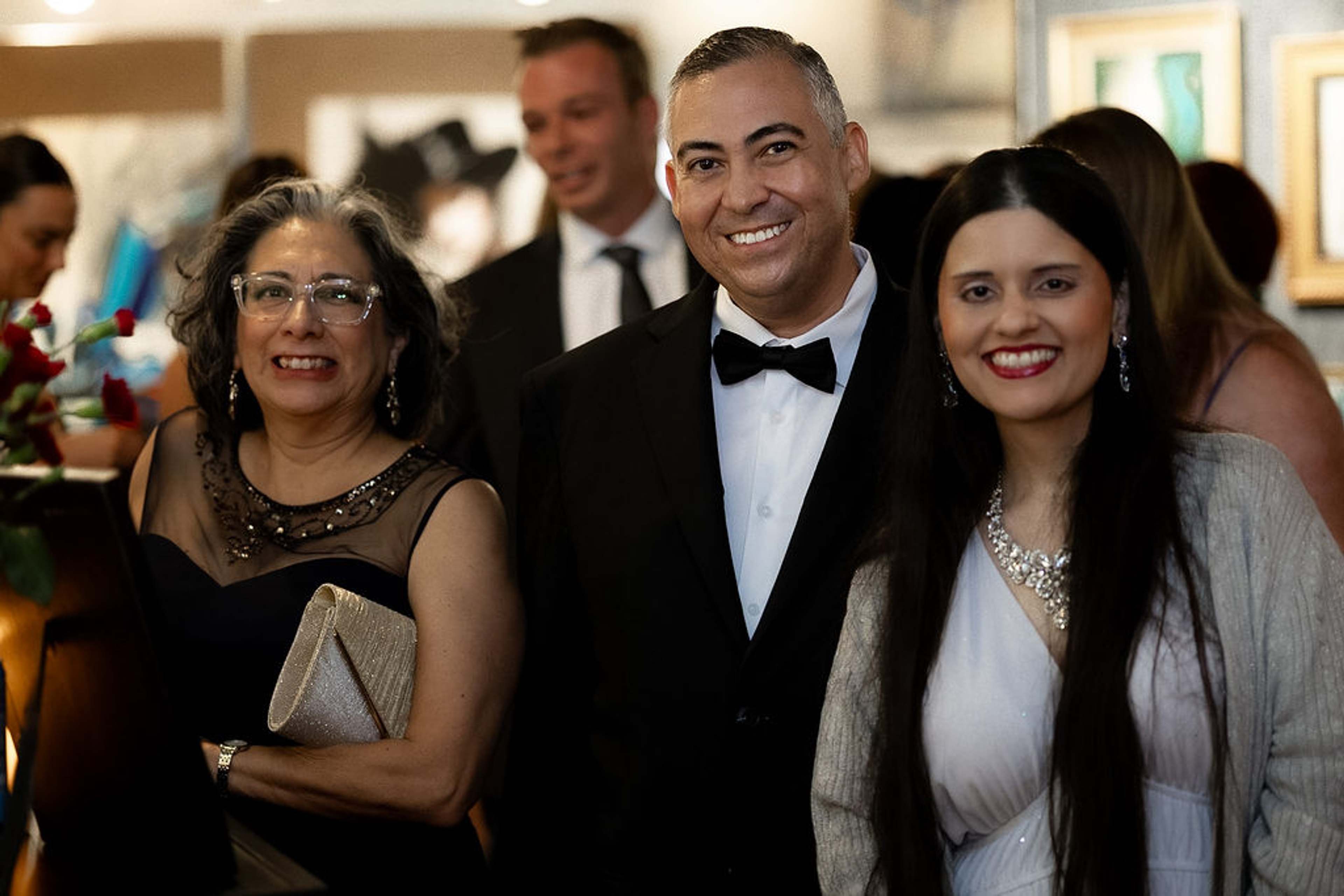 Four guests posed together in evening wear