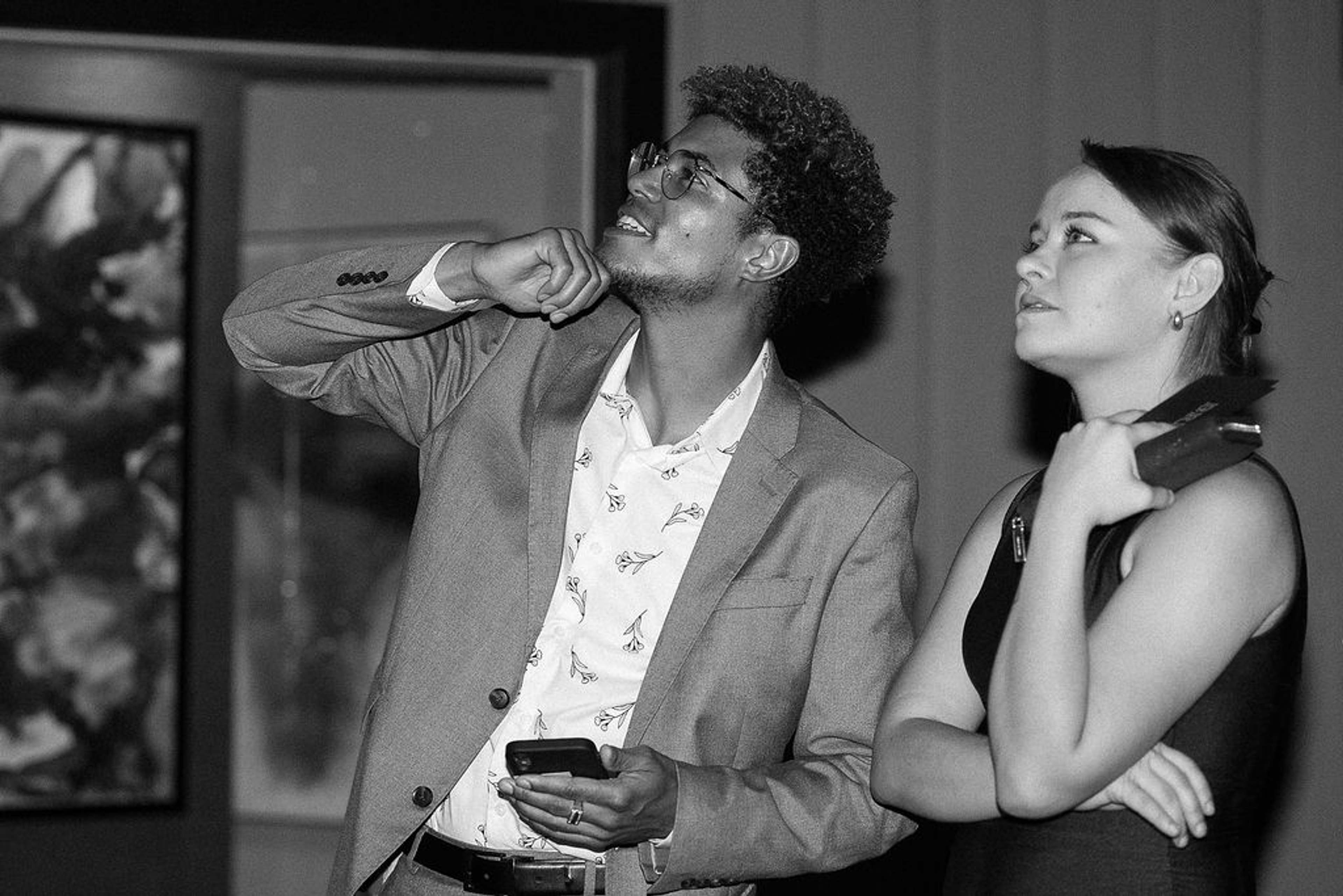 Two guests watching the presentation