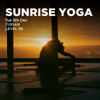 Woman doing yoga with sunrise in background