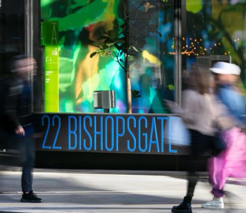 People walking past 22 Bishopsgate sign