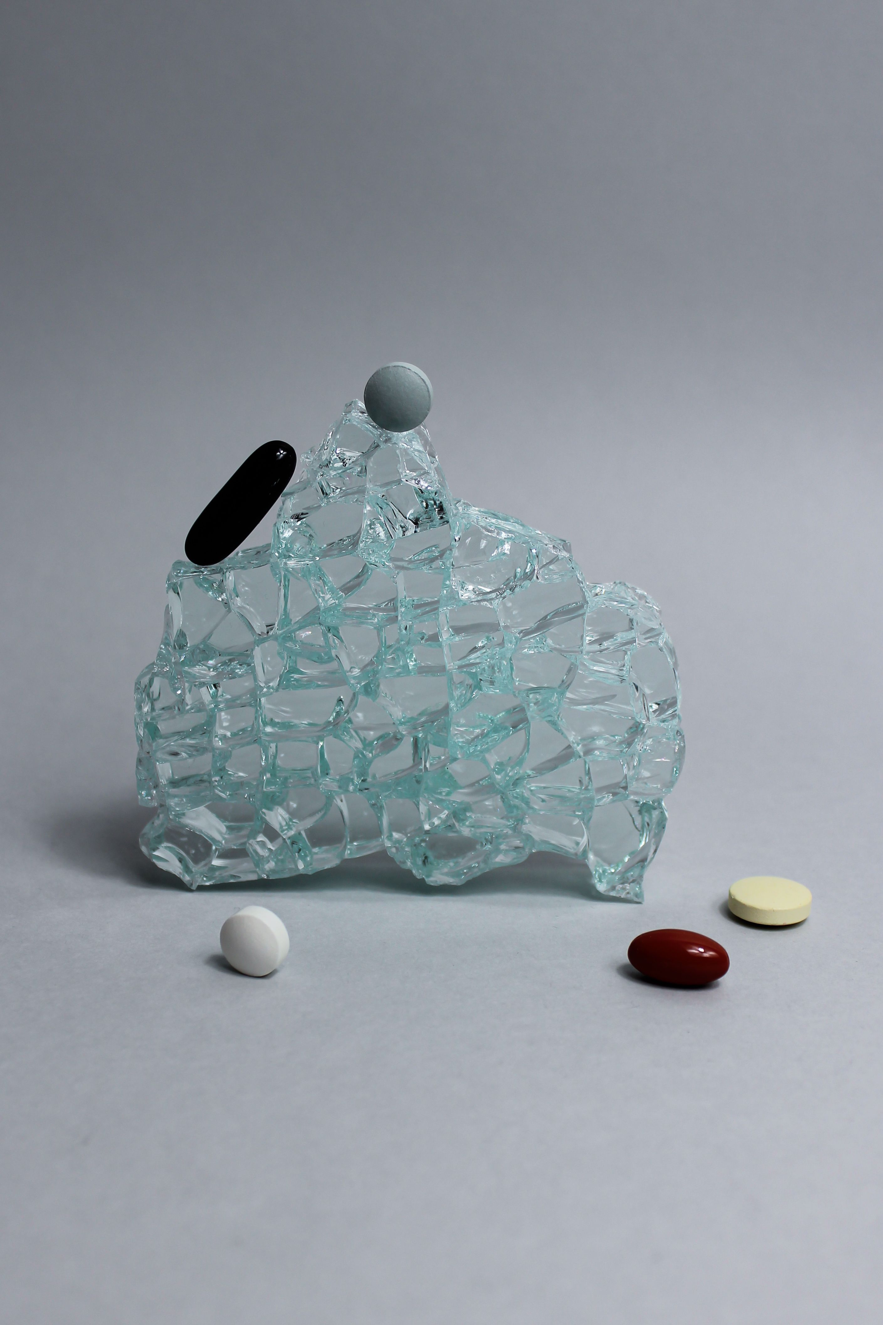Glass tile surrounded by pills