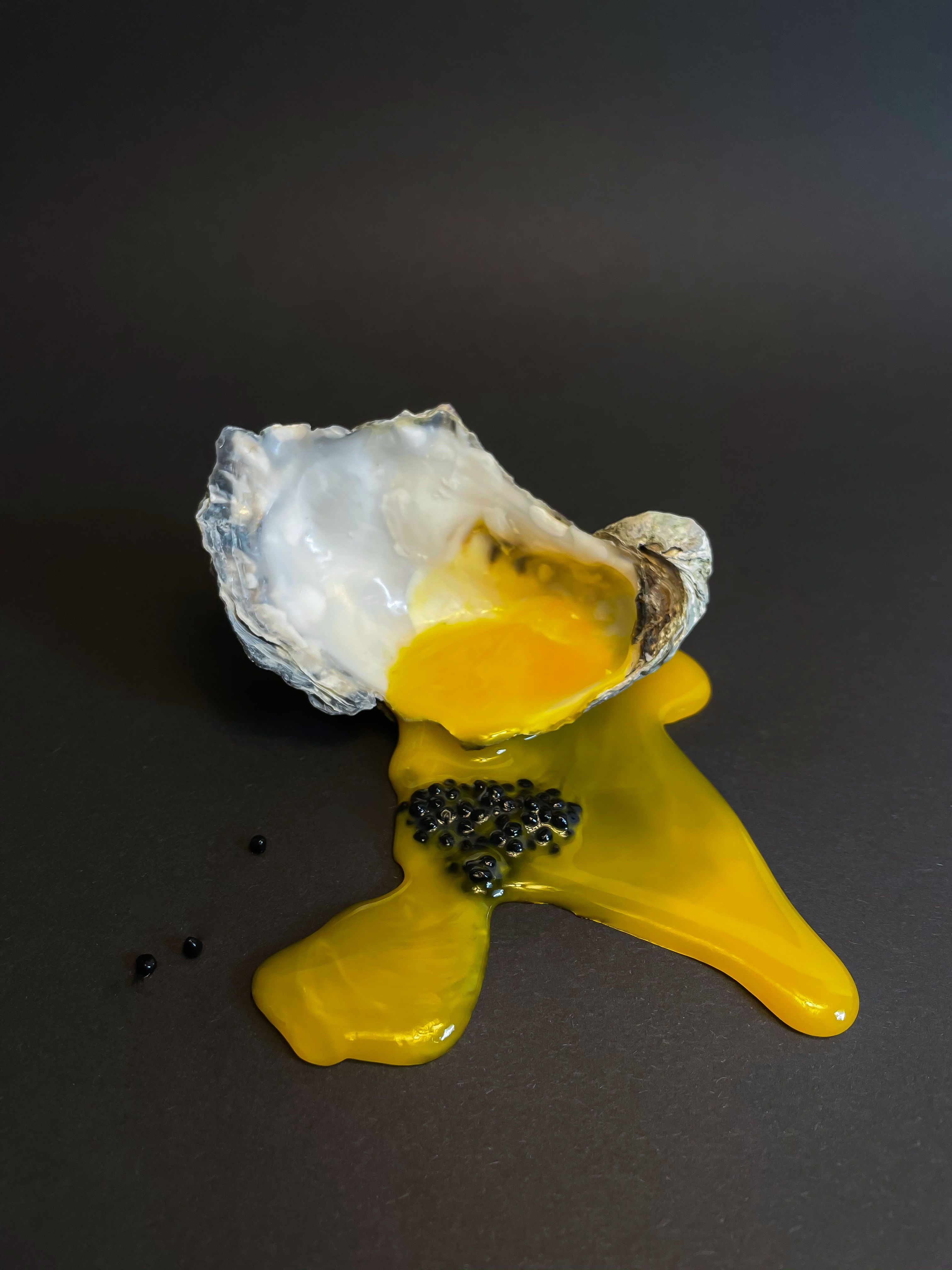 Oyster with egg yolk and caviar