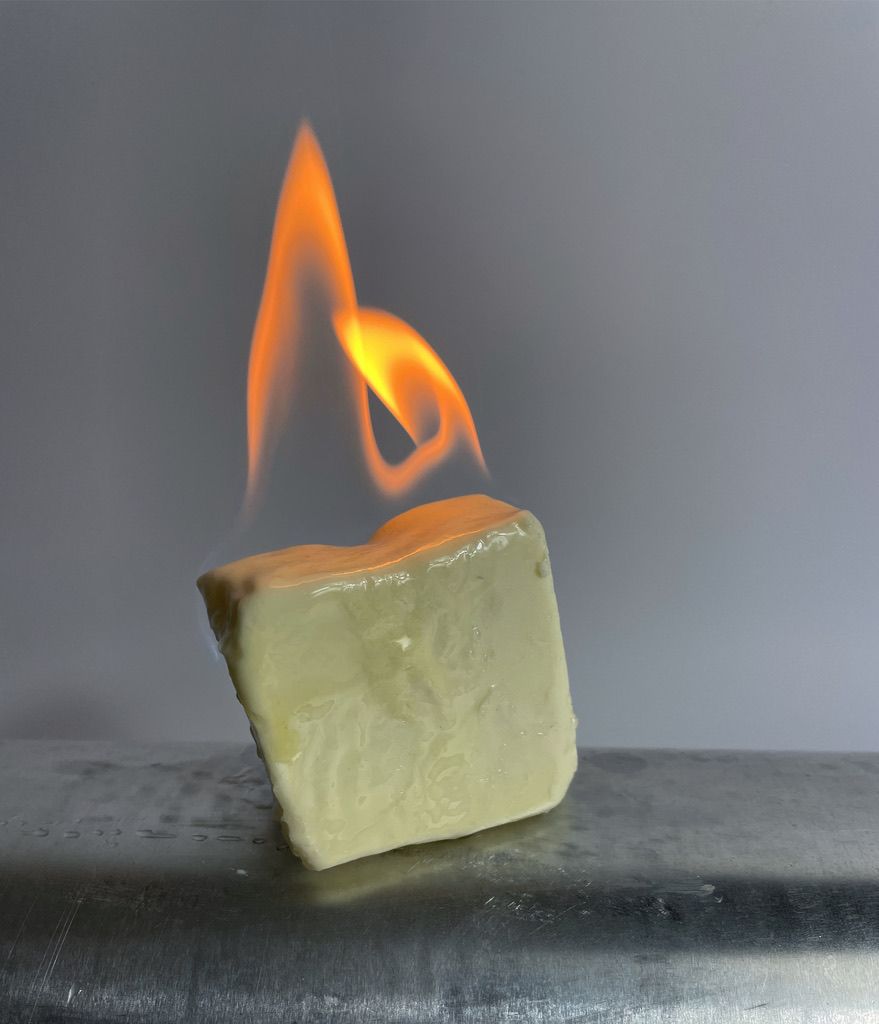 Burning butter placed on an aluminium pipe