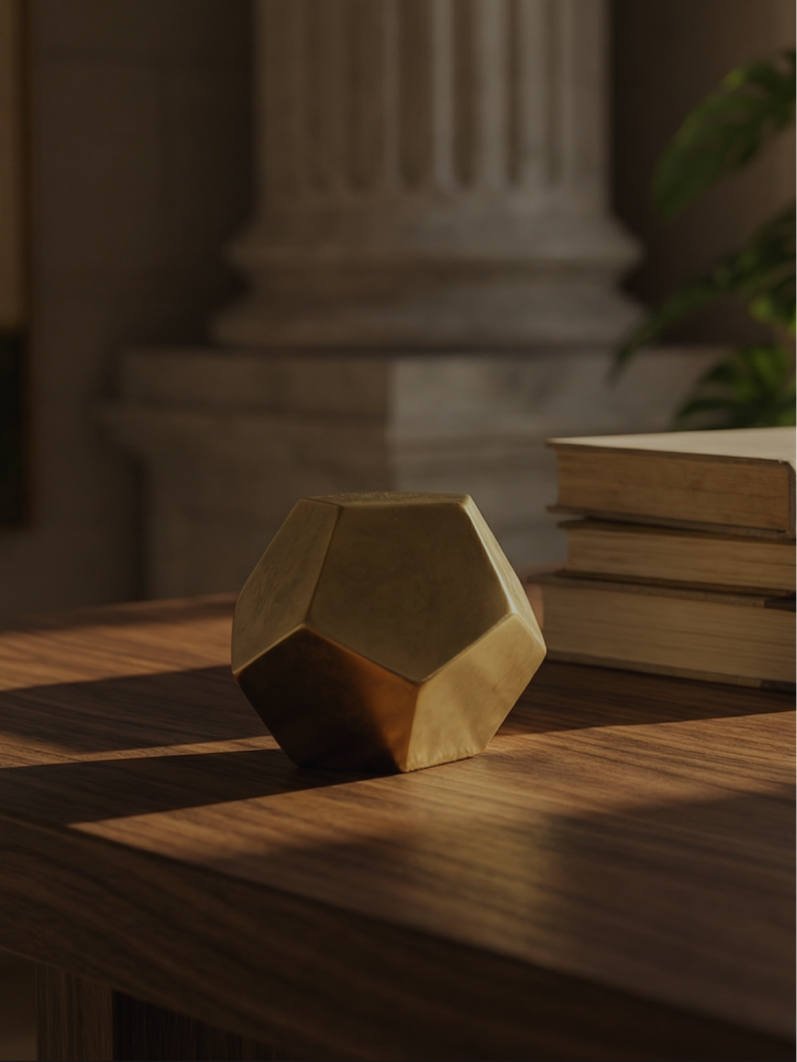 Stone column and wooden desk with a geometric paperweight, representing the Finance practice area