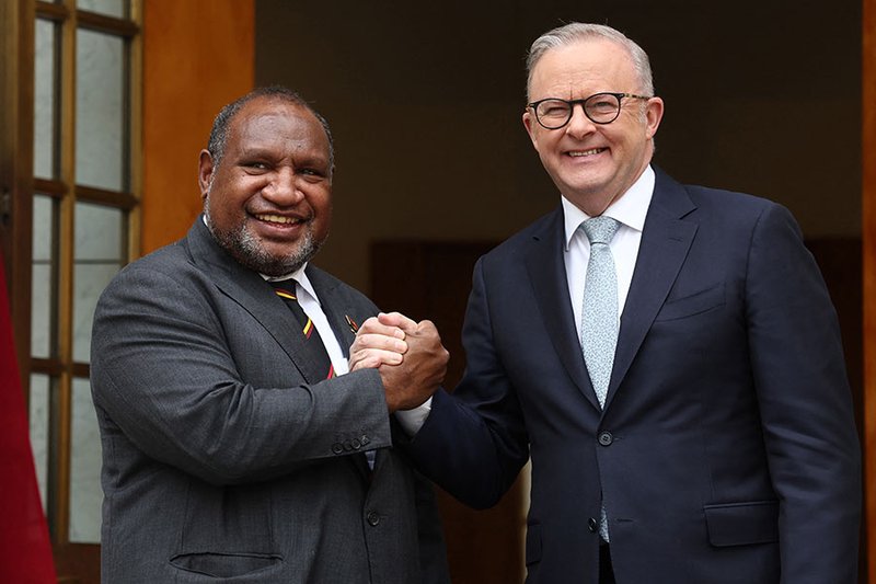 Australia's Prime Minister Anthony Albanese (R) greets Papua New Guinea's Prime Minister James Marape at Parliament House in Canberra on 6 October 2025 before signing a mutual defence treaty (David Gray/AFP via Getty Images) 