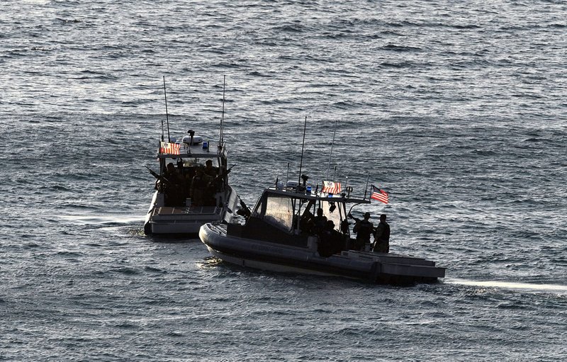 United States coast guards patrol the harbour ahead of the 2018 APEC summit in Port Moresby (Saeed Khan/AFP via Getty Images)