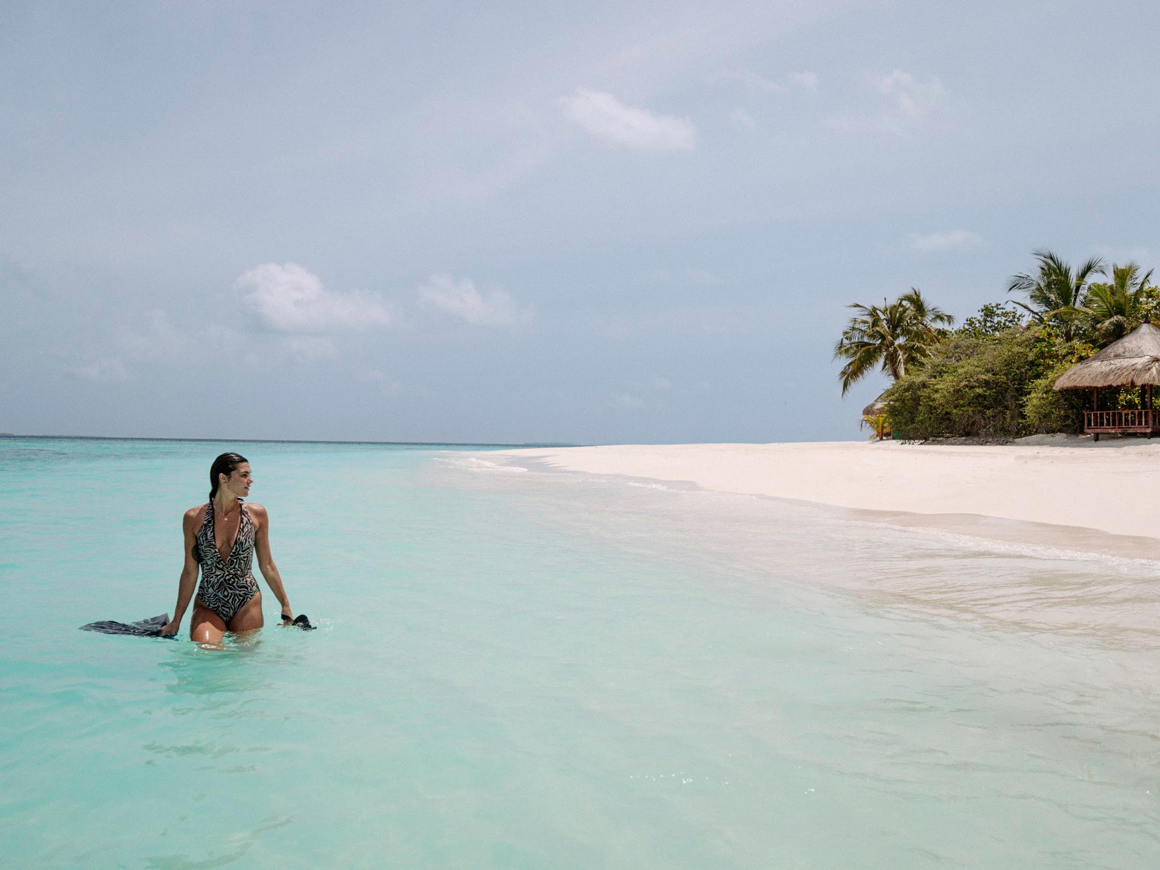 Guest on the white-sand beach at Vabbinfaru