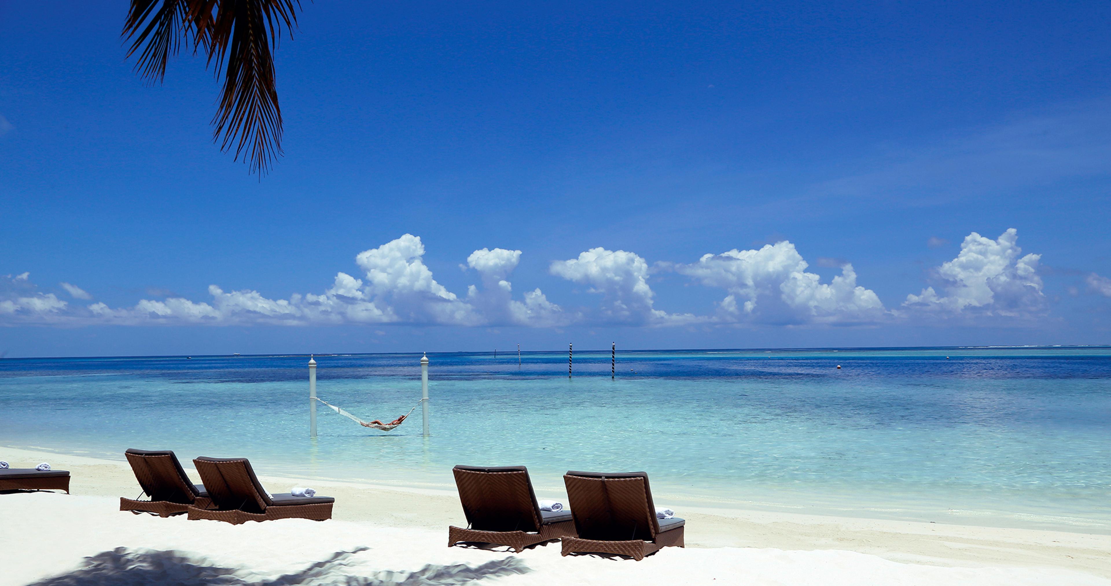 Sun loungers on the white-sand beach at Nika Island