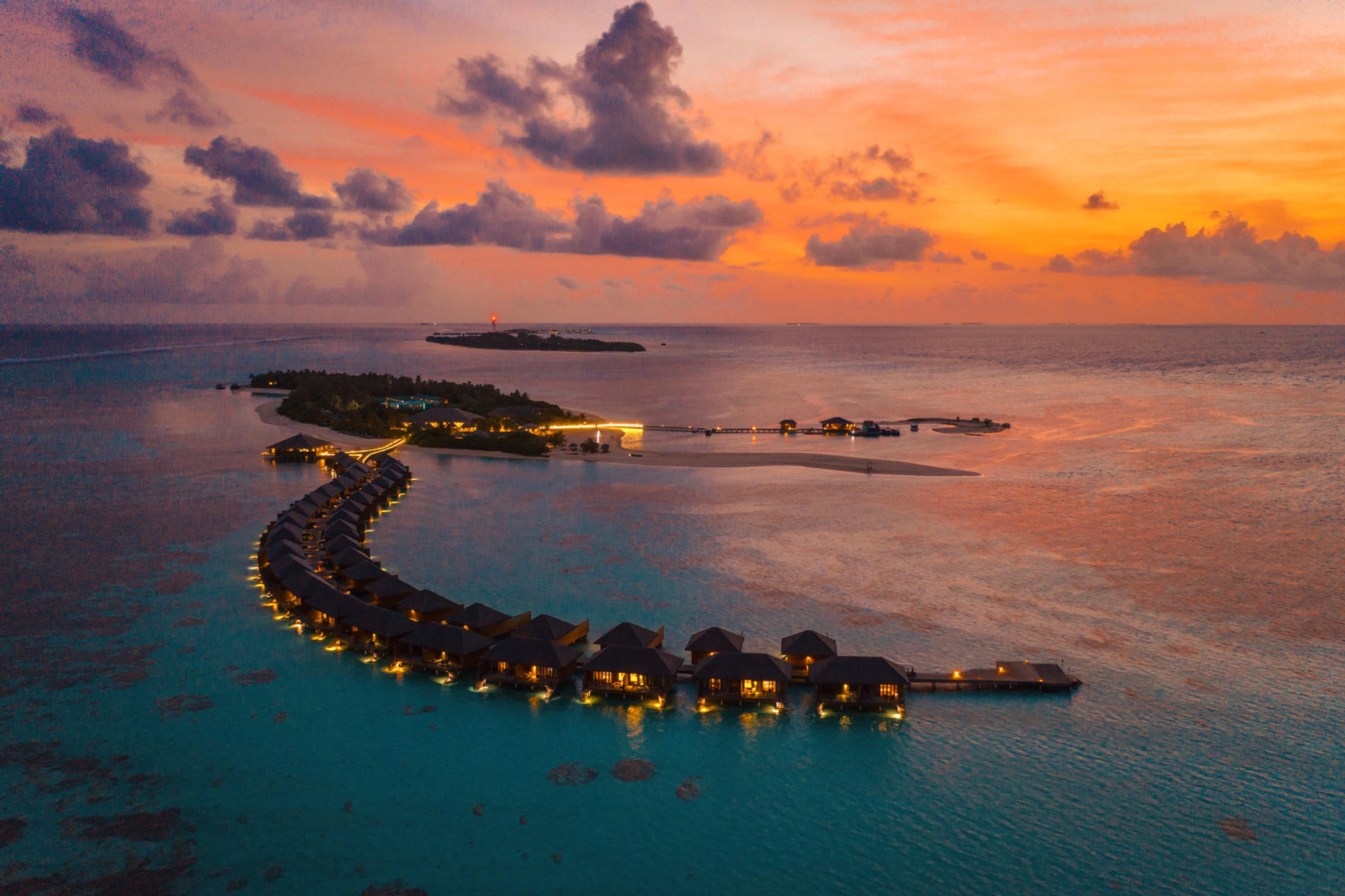 Sunset over the lagoon villas at Cocoon Maldives