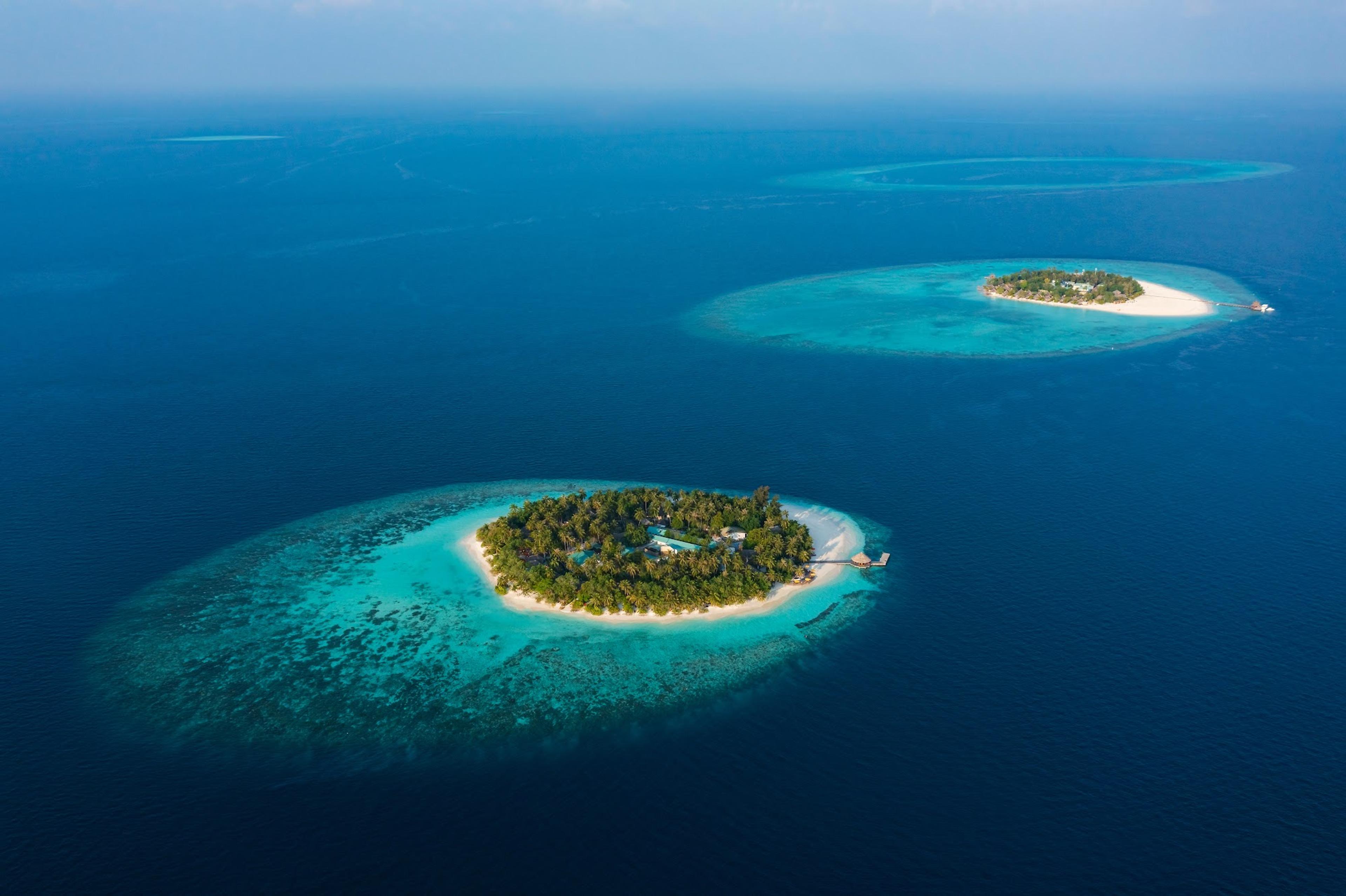 Twin islands and turquoise lagoon in North Malé Atoll from the air