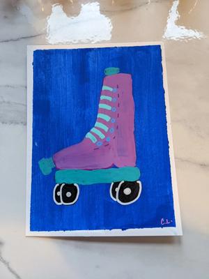 a painted pink rollerskate with jade blue trim