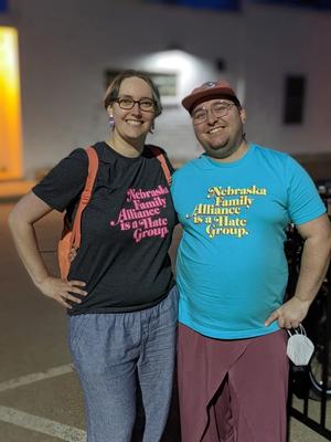 two people wearing t-shirts that read "Nebraska Family Alliance is a Hate Group"