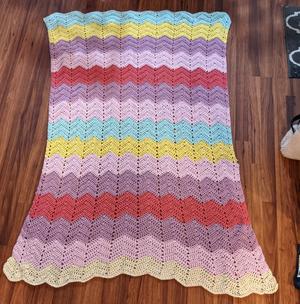 a zig-zag striped pastel crocheted baby blanket 
