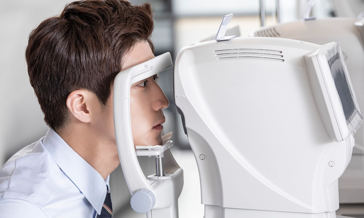 An ophthalmologist reviewing corneal measurements during a pre-operative assessment.