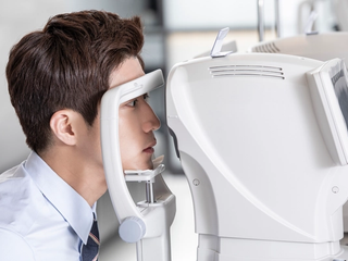 An ophthalmologist reviewing corneal measurements during a pre-operative assessment.