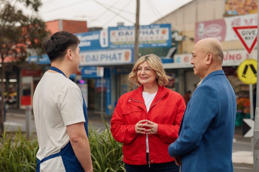 Natalie talking with local traders on a shopping strip