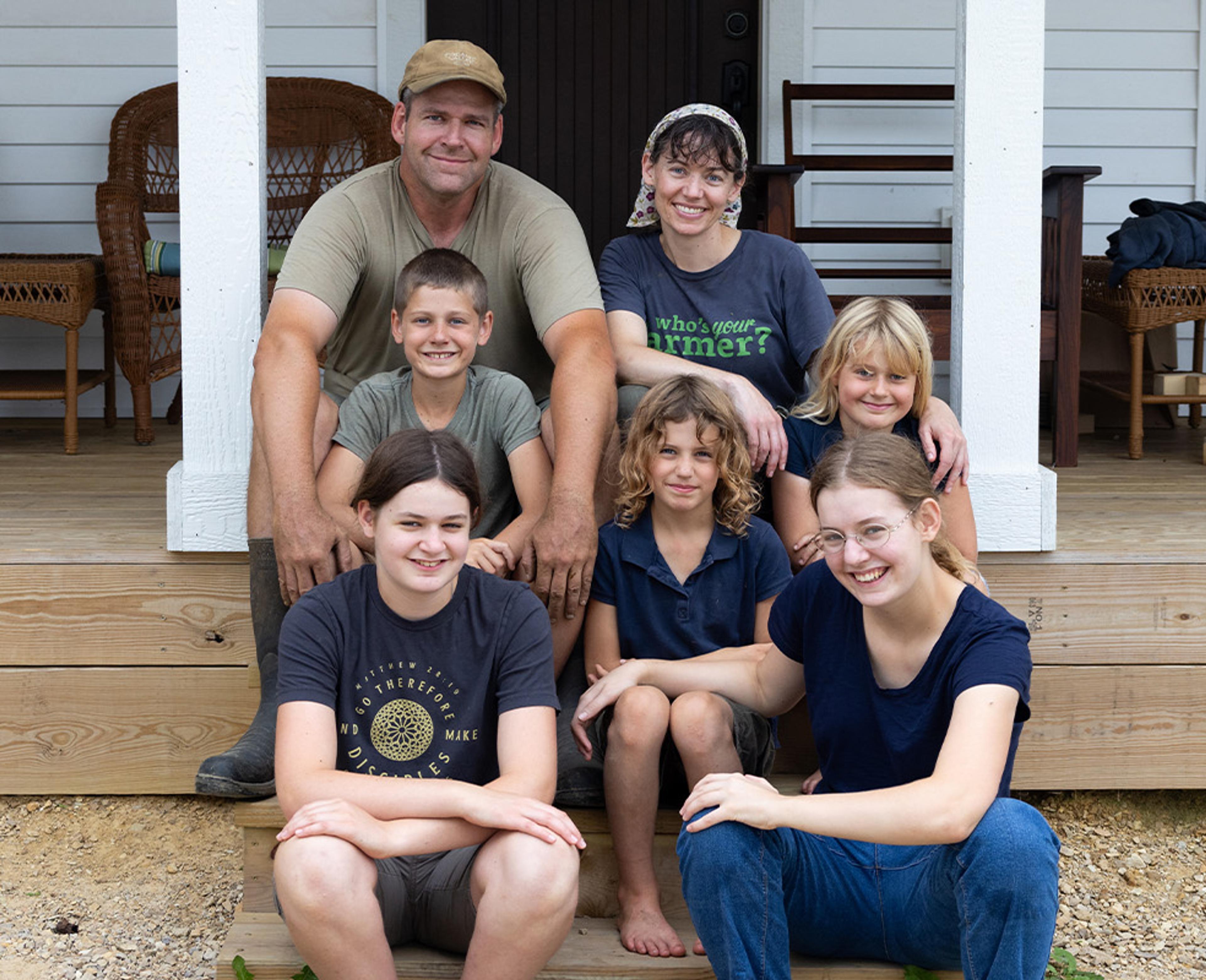 Seven members of the Canter family sit on the steps of their Wisconsin home.