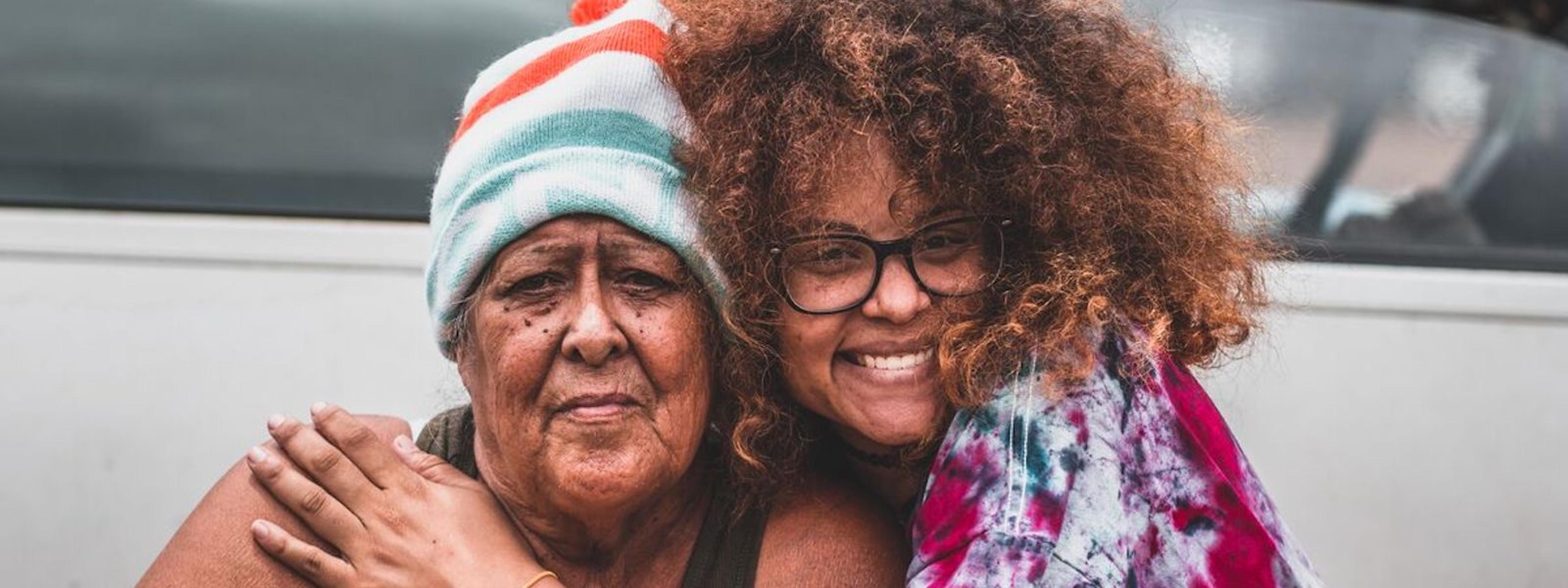 LaRayia Gaston poses for a photo with a homeless woman