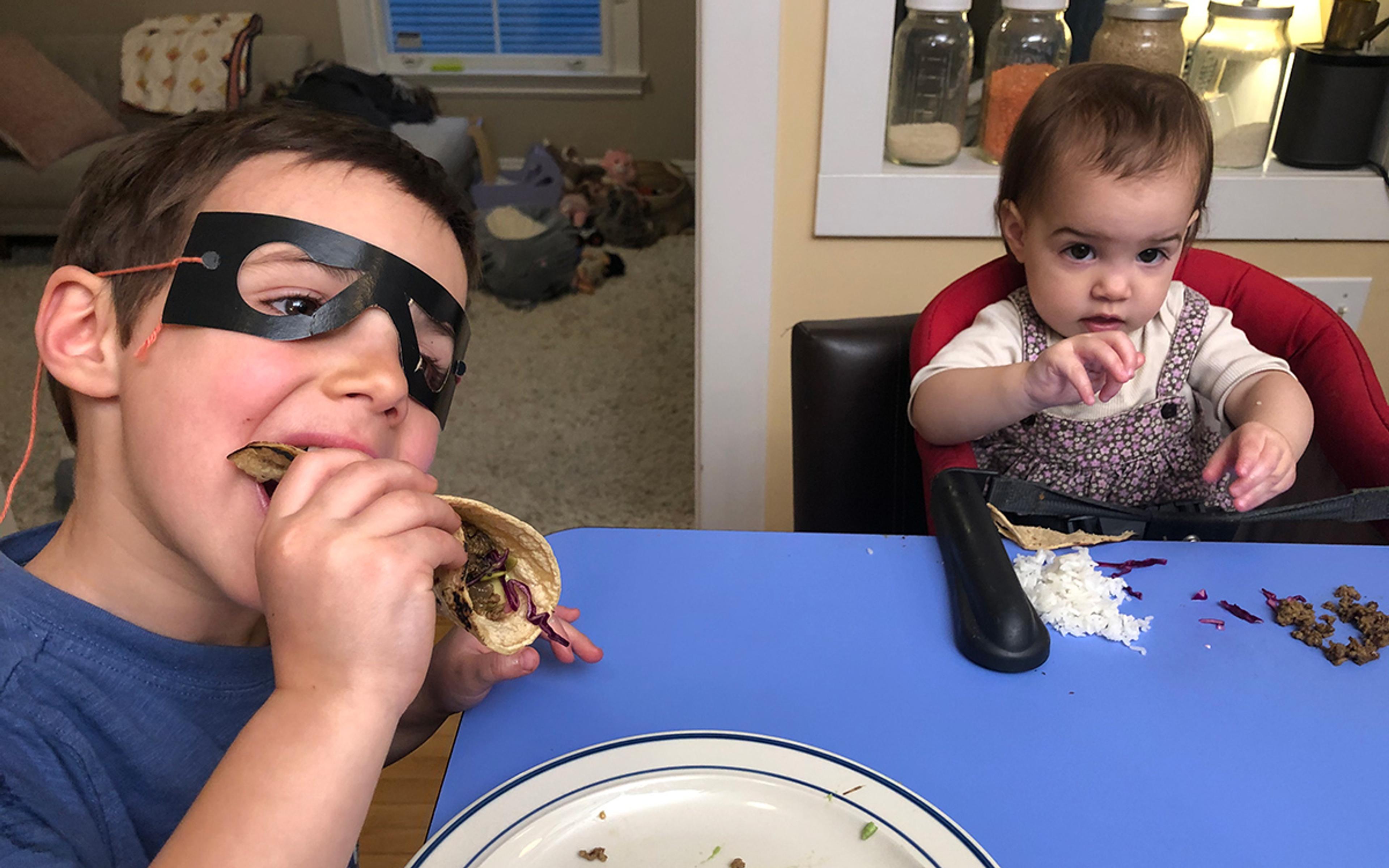 Kids eating dinner at the table. Photo by The Perennial Plate.