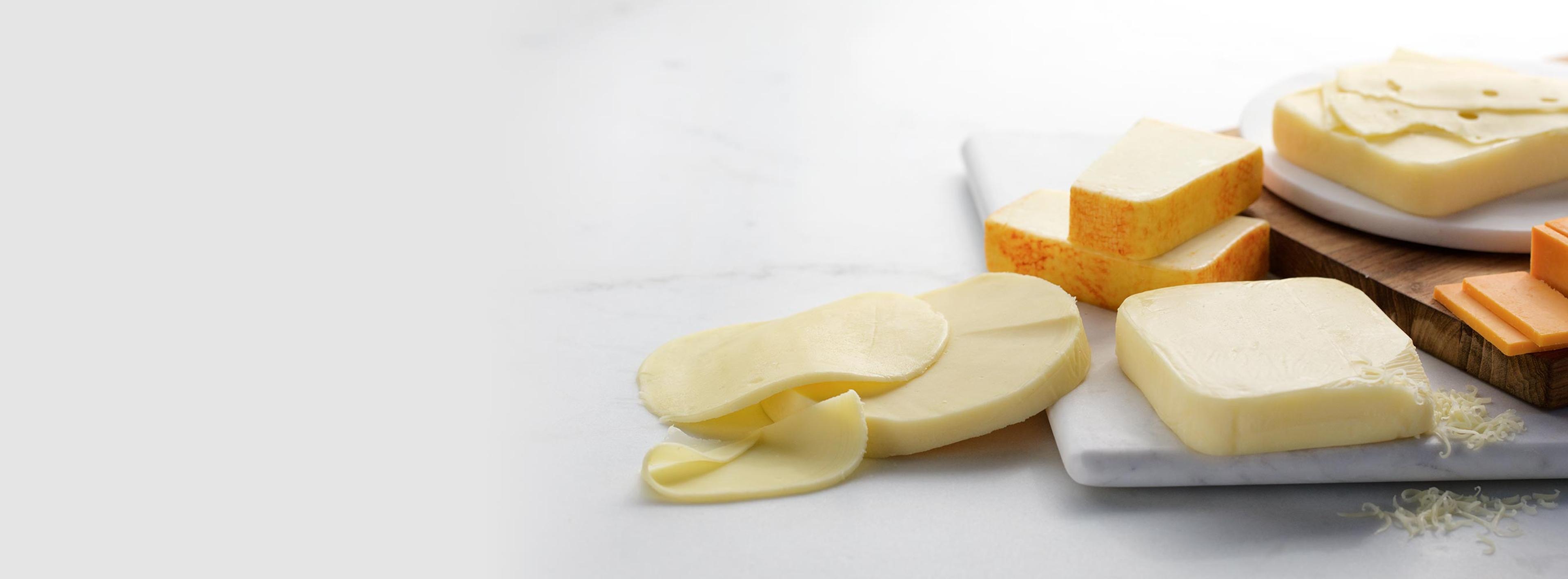 A plate of assorted blocks of cheese.