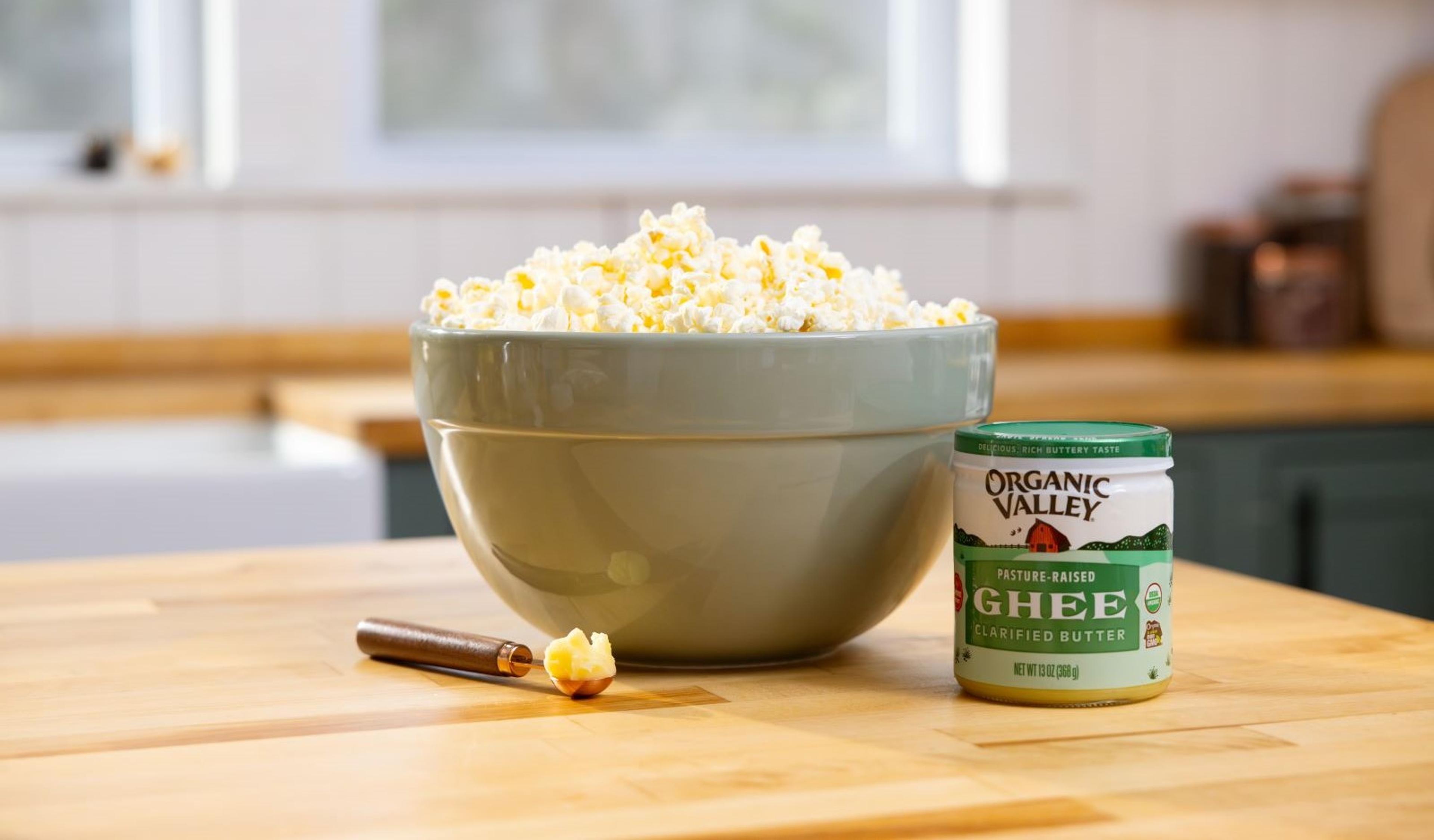 Organic Valley Ghee next to a bowl of popcorn.