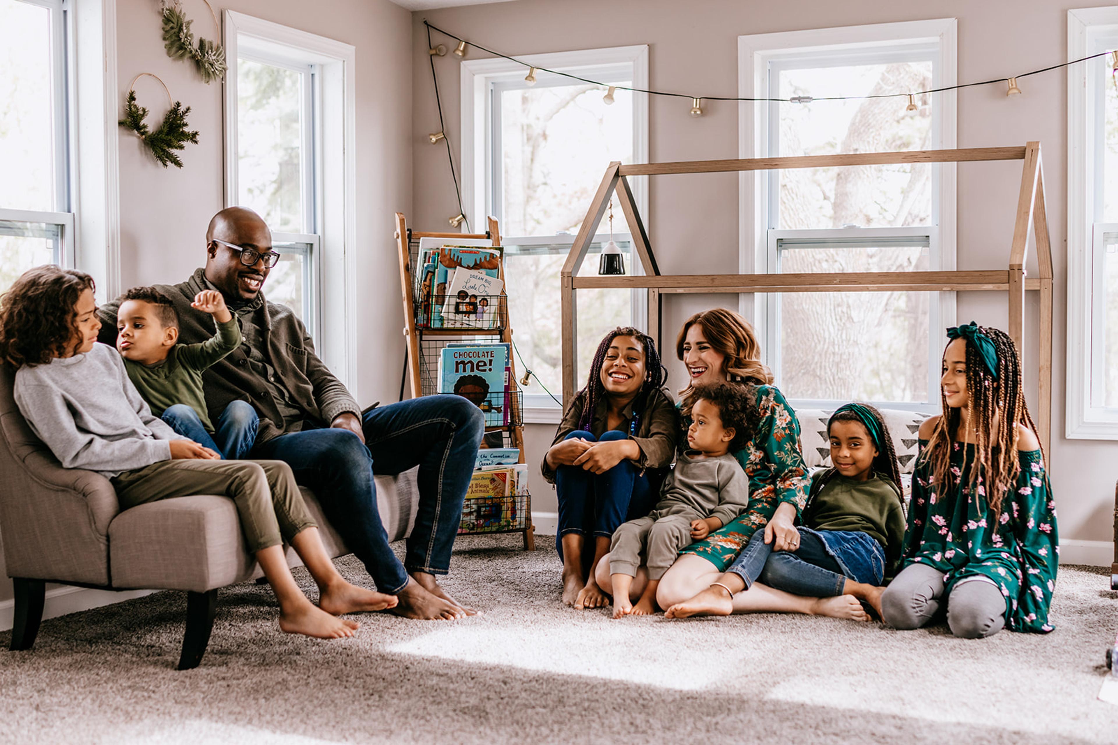 Megan Joy Yancy and family sit together in the living room.