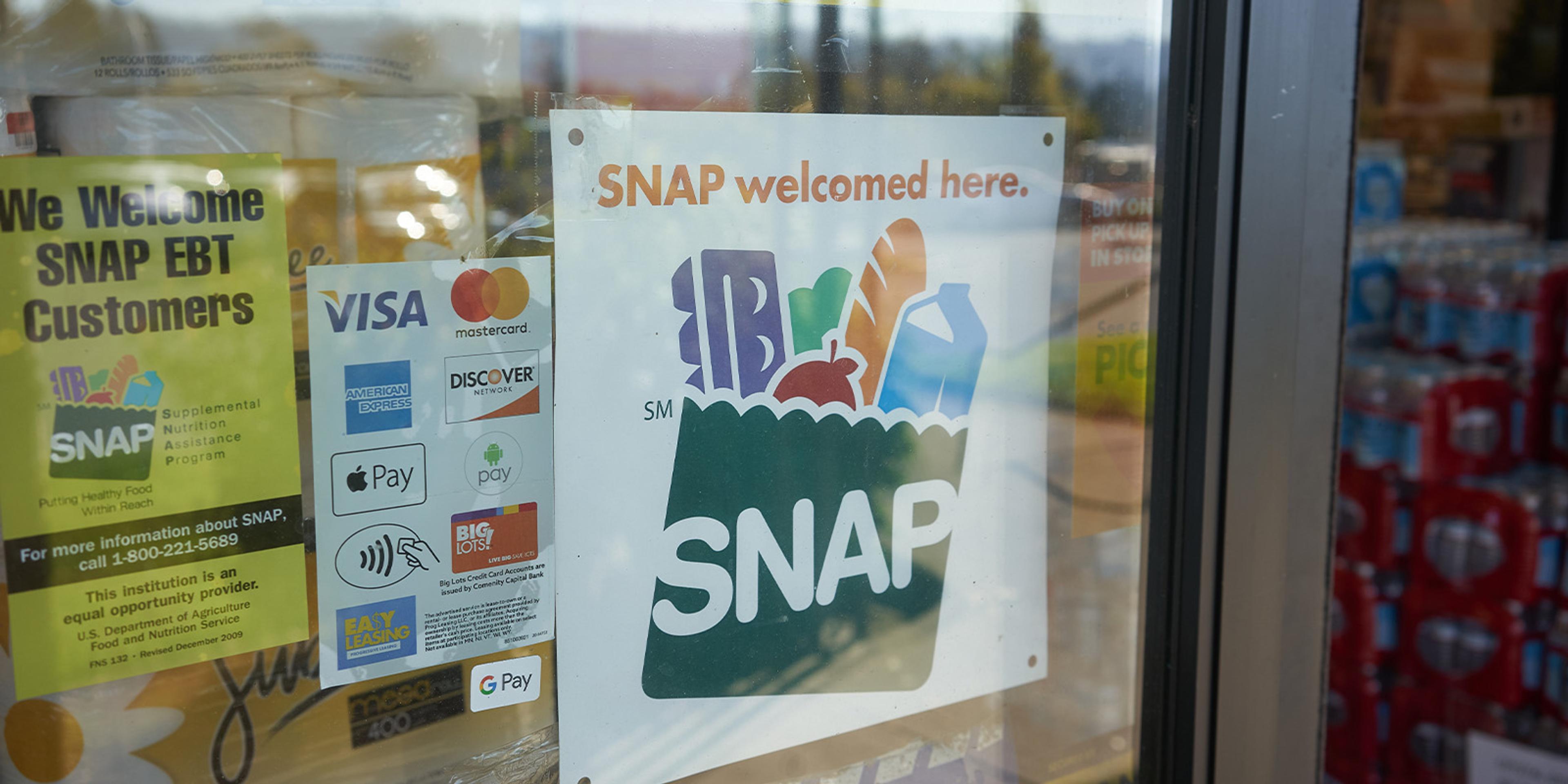 A SNAP welcomed here sign in a store window.