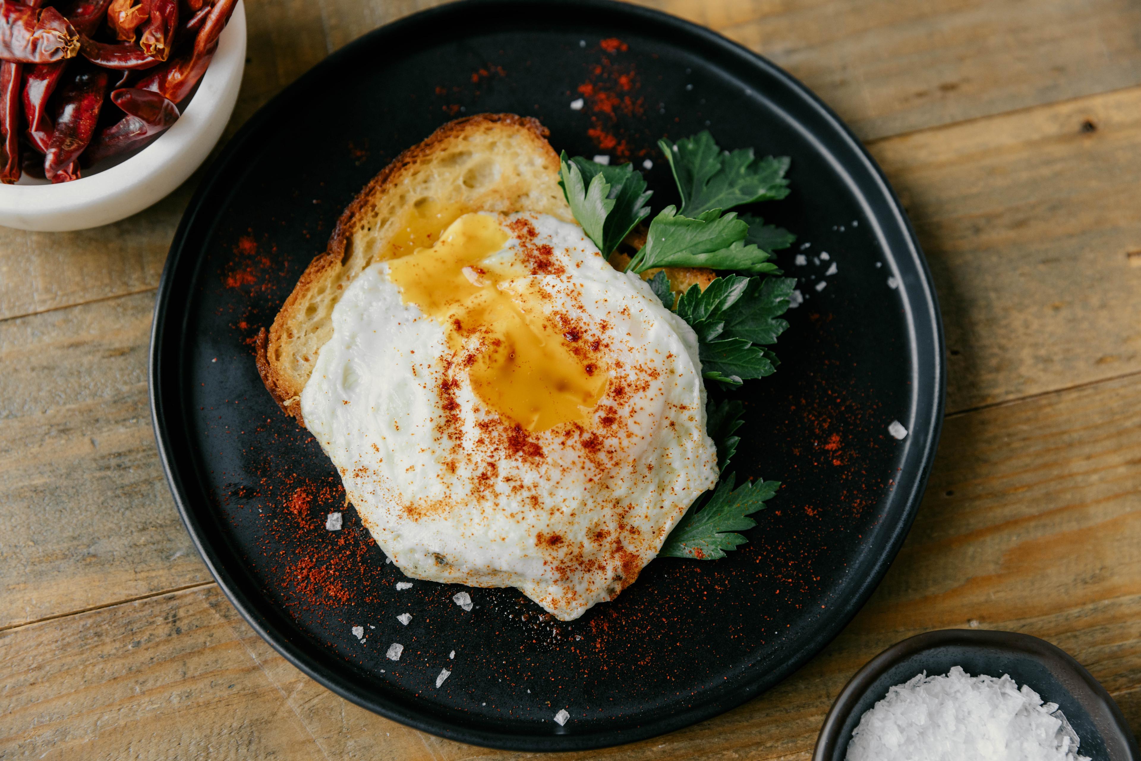 An over easy egg with chili powder.