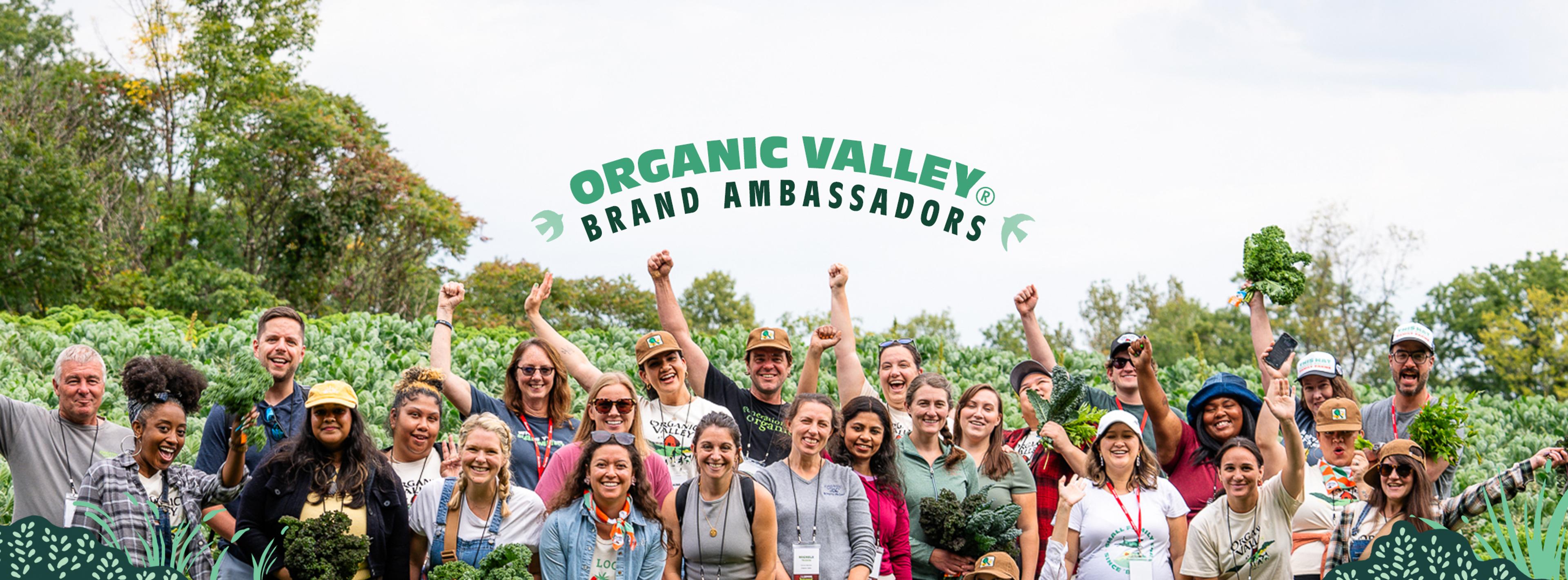 People from Organic Valley's Ambassador Program with cows in the background.