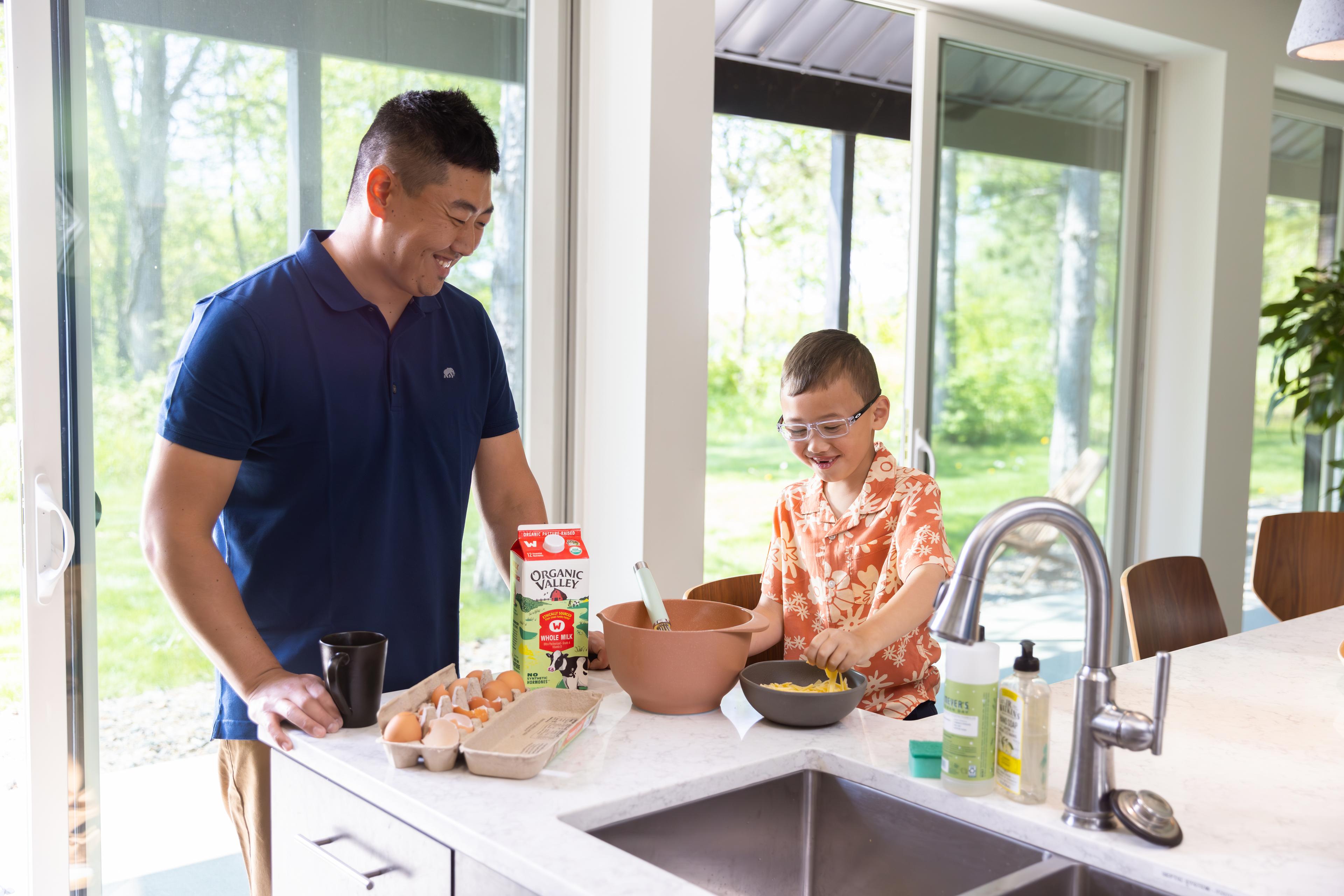 A father and son make cheesy eggs using organic milk, cheese and eggs.