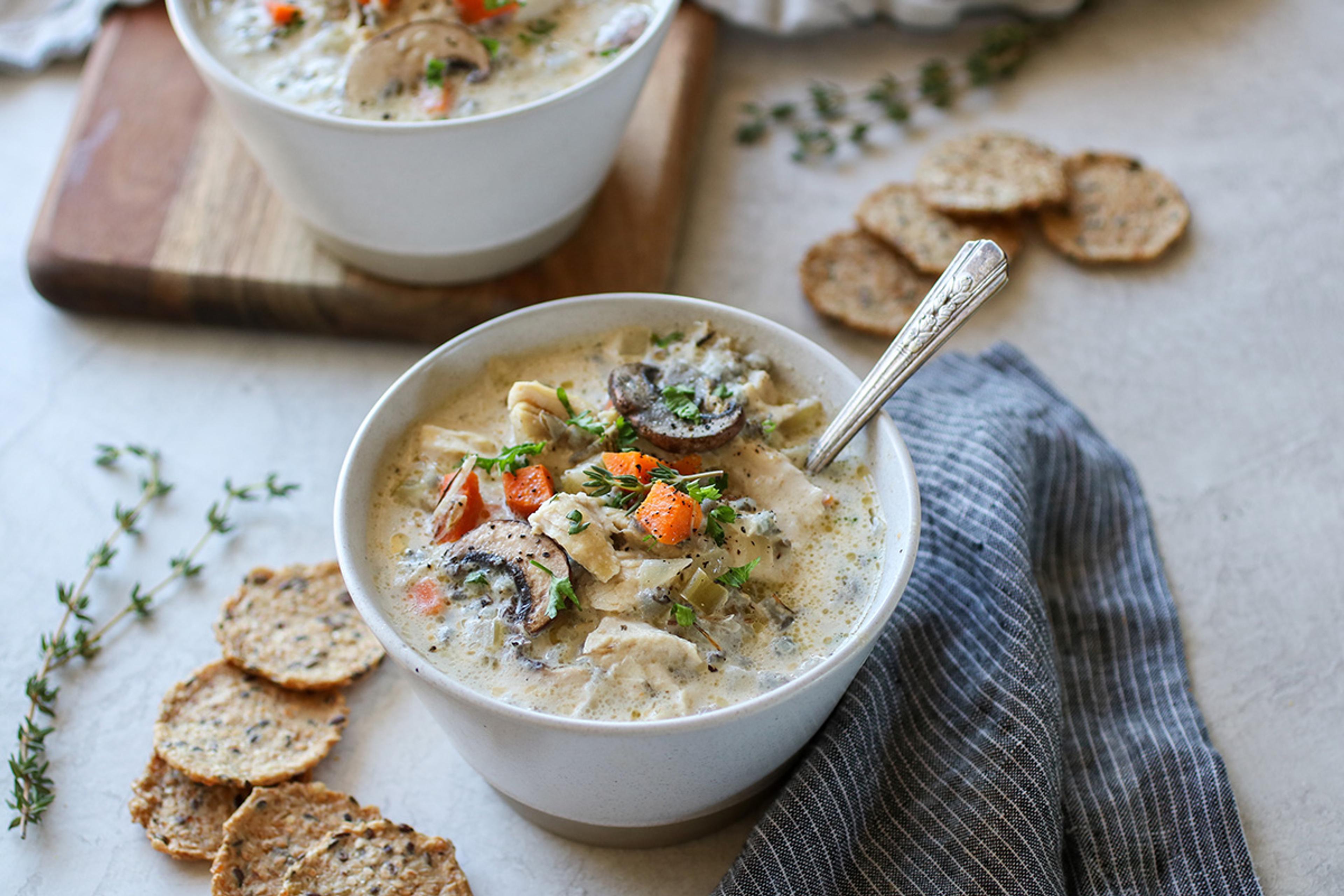  A hearty chicken and wild rice soup loaded with chicken, carrots, and mushrooms, topped with a sprinkle of pepper.