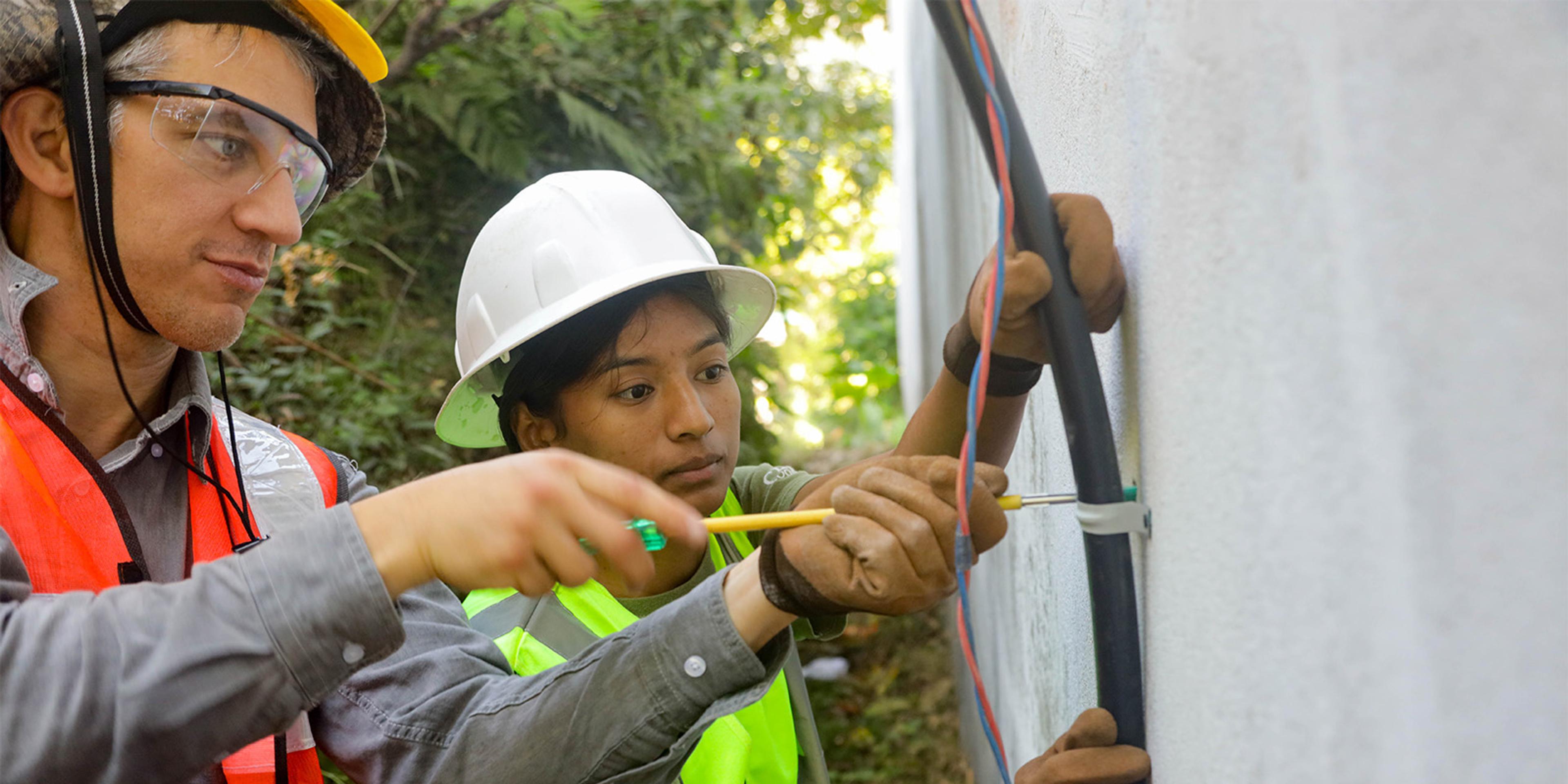 People work on a solar project.