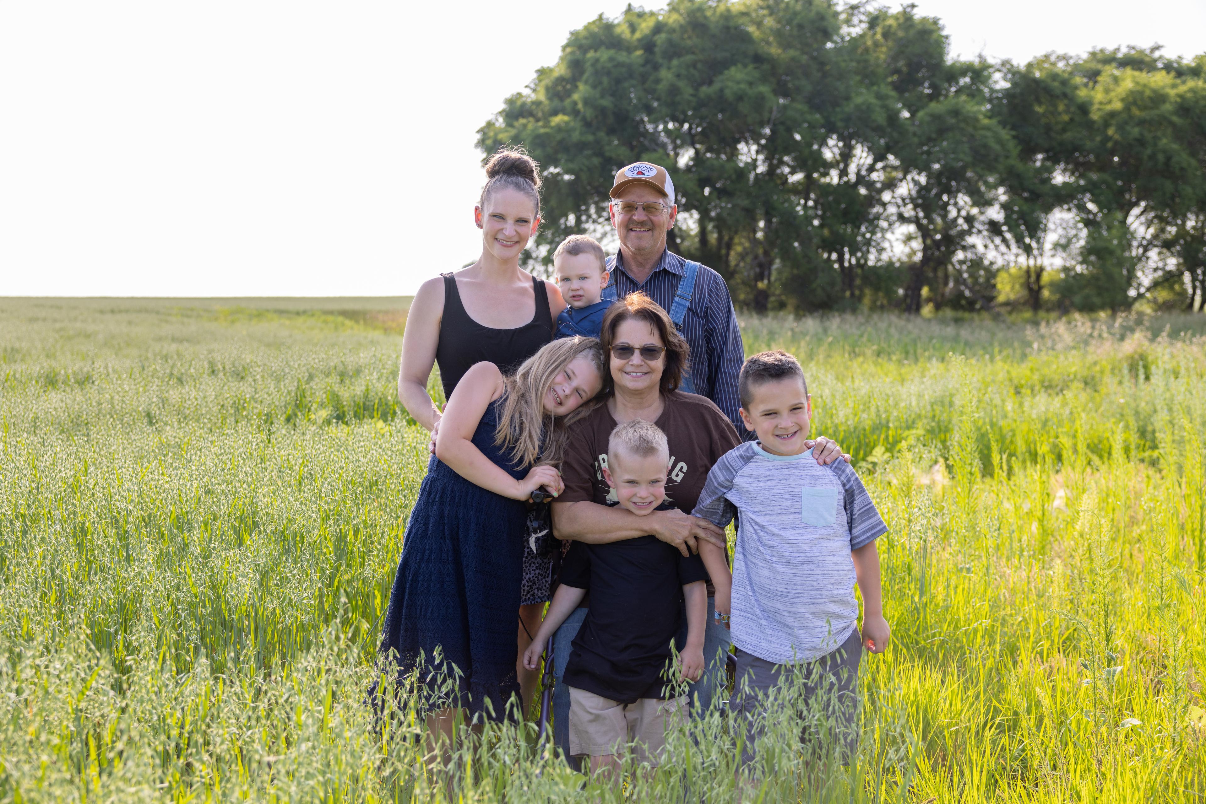 Seven Members of a farm family stand in an oat field