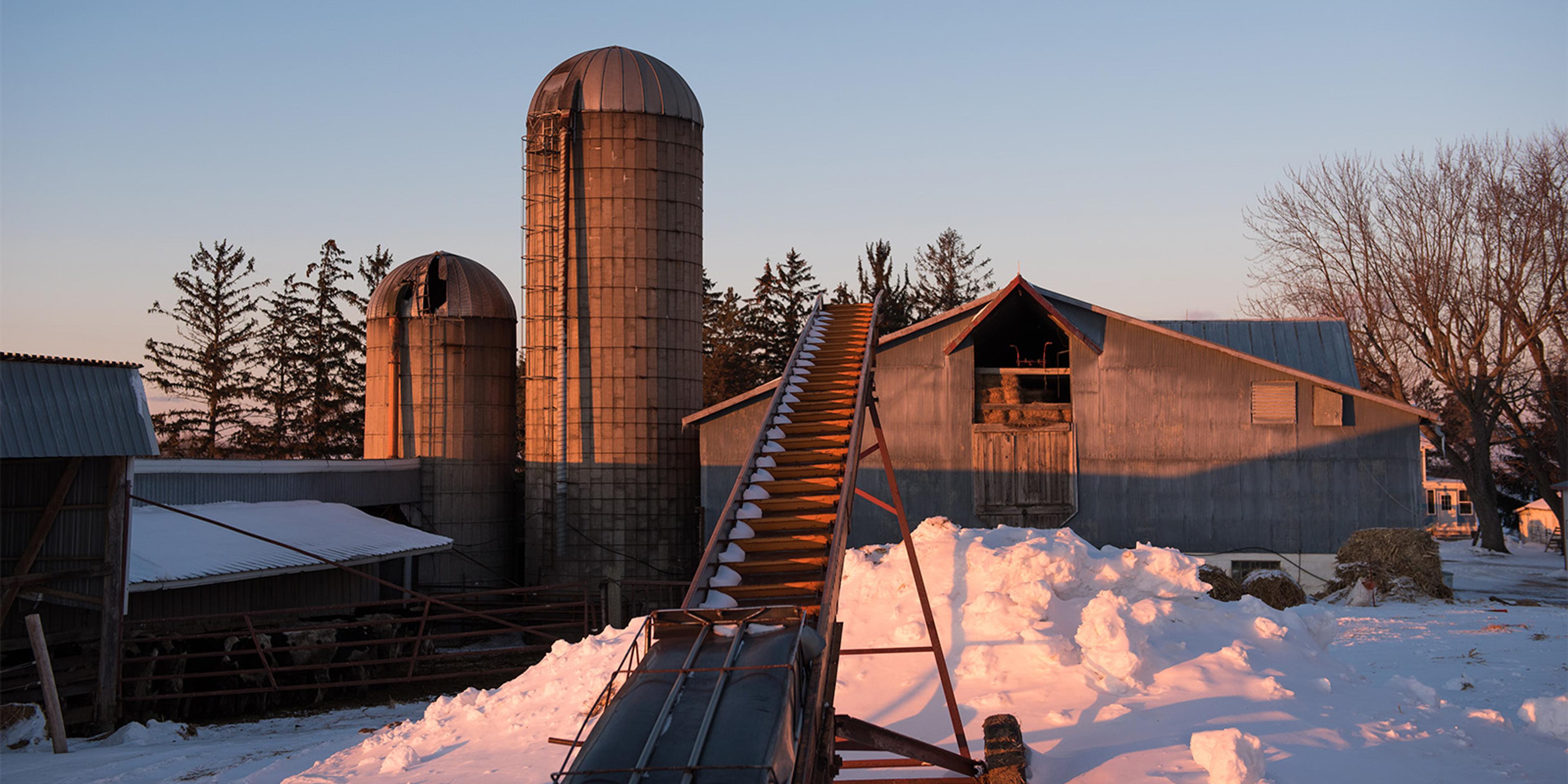 A hay elevator in the snow.
