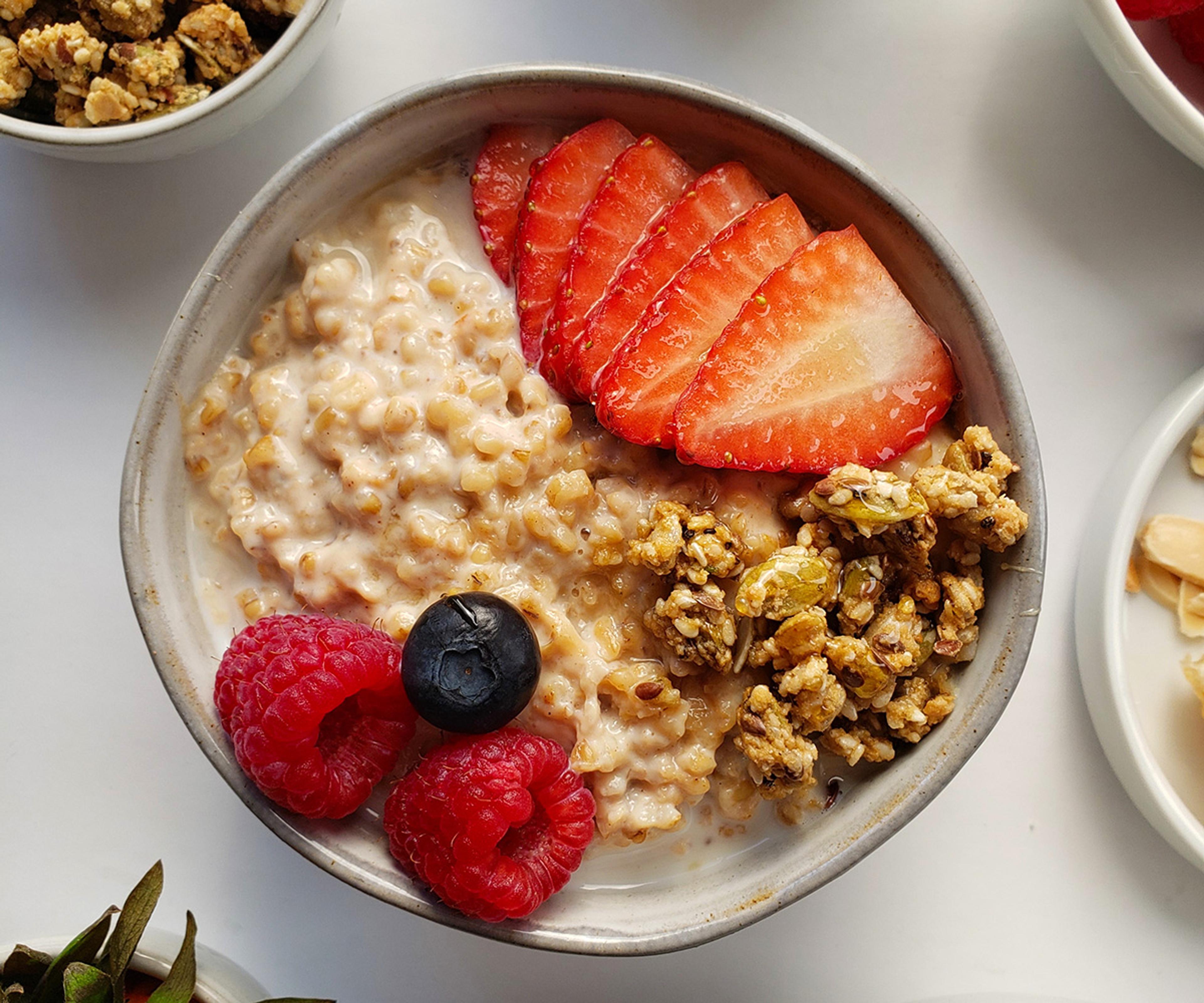 A beautifully presented bowl of oatmeal topped with fruit and granola.